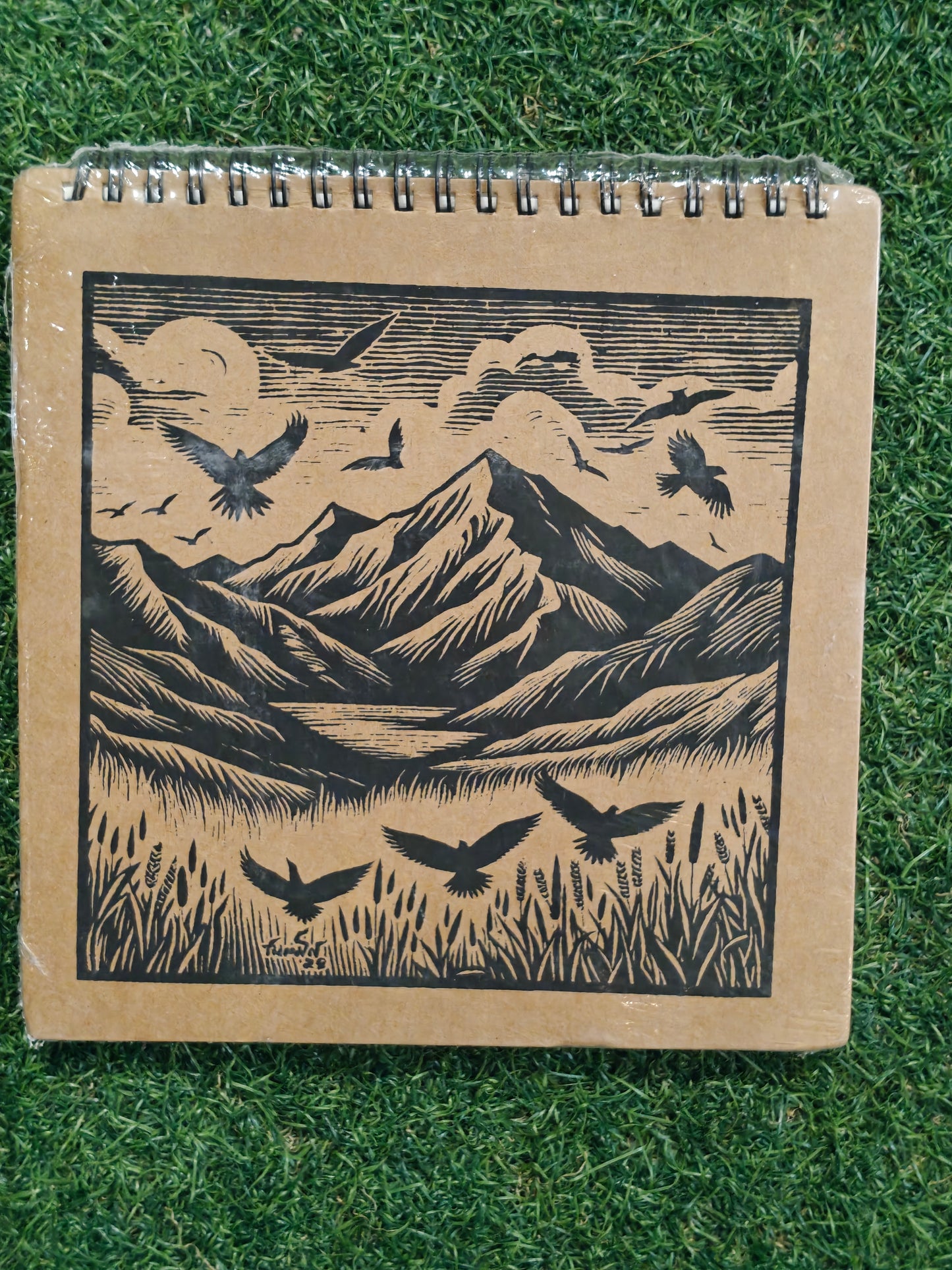 Hand made paper sketchbook with brown board cover and spiral binded