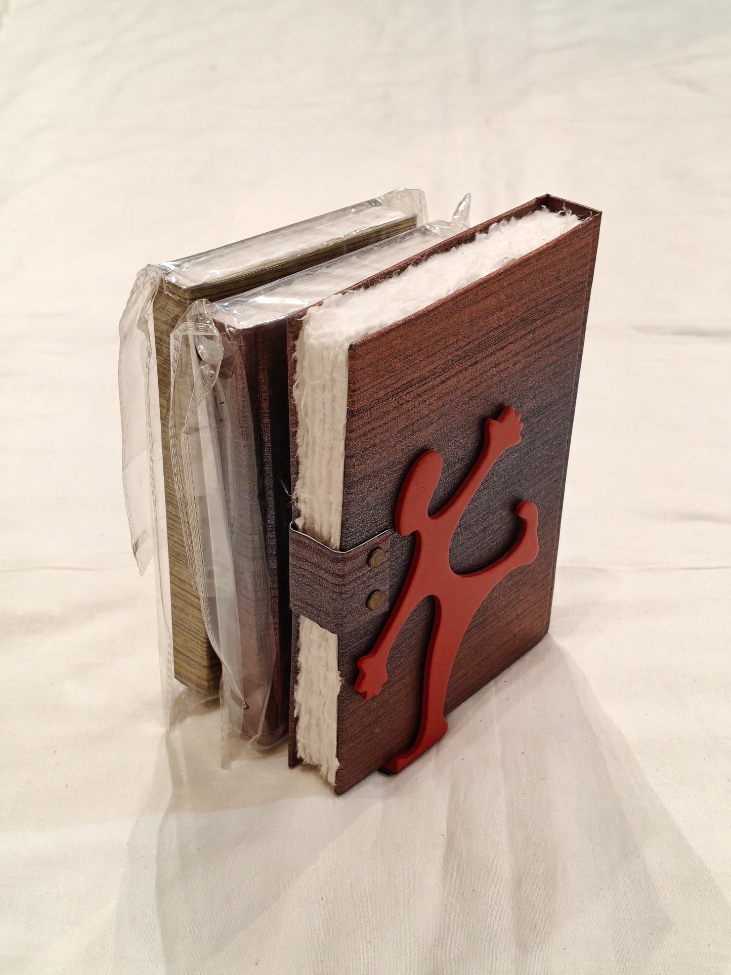 Red coated steel bookends pair - person holding it all design