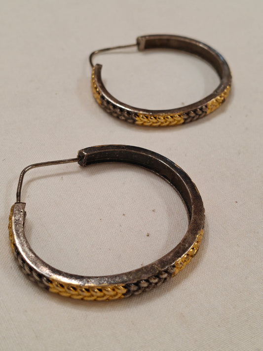 Gold and silver hoop earrings with braided design
