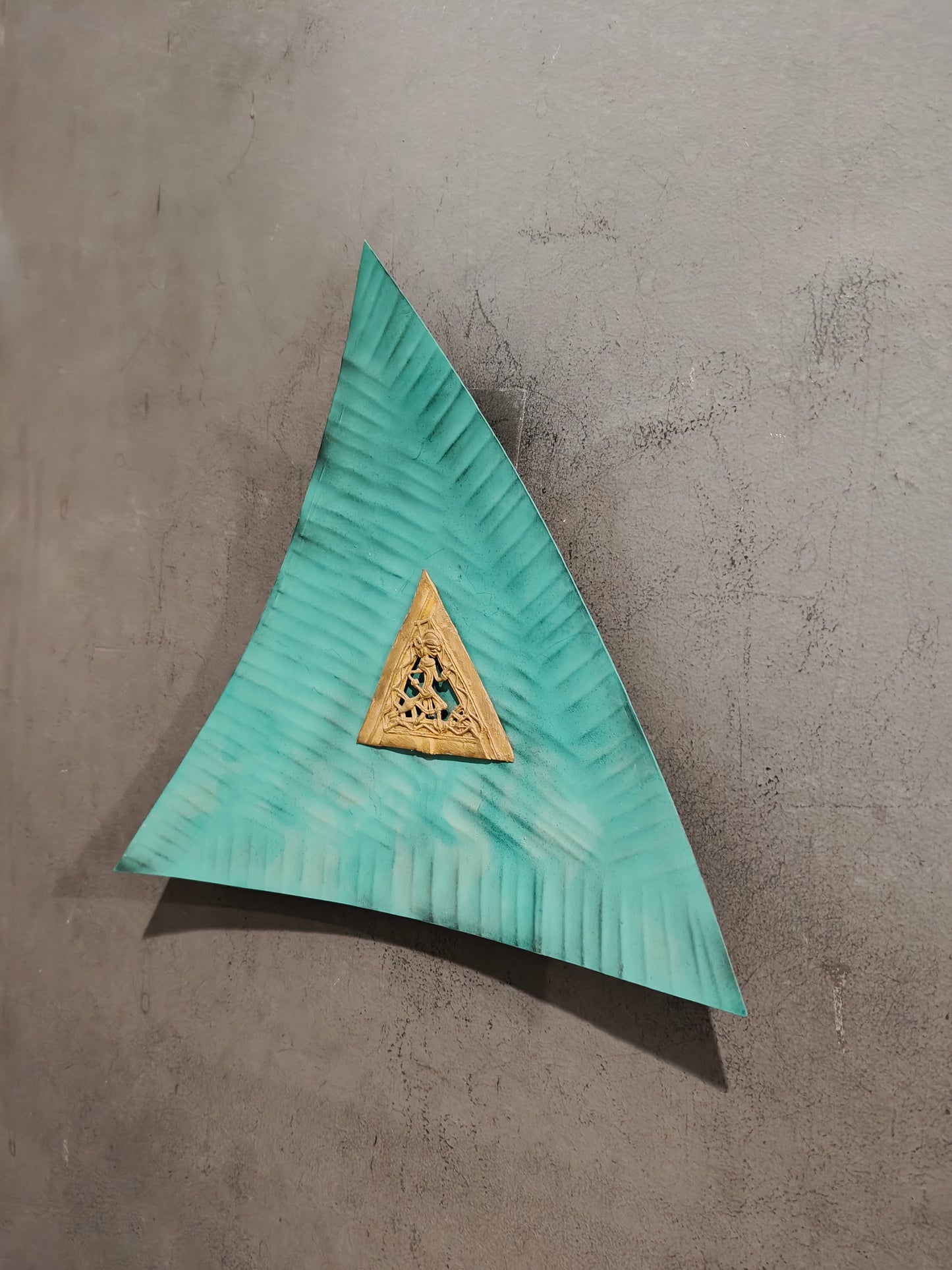 Green concave triangle with brass dokra frame in the middle