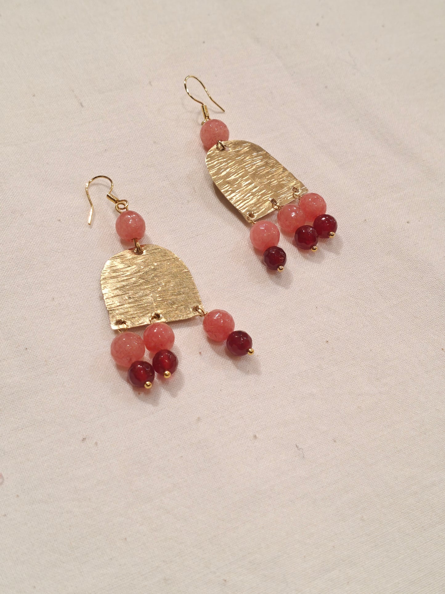 Long semi-circular brass handcrafted hook earrings with peach and red beads