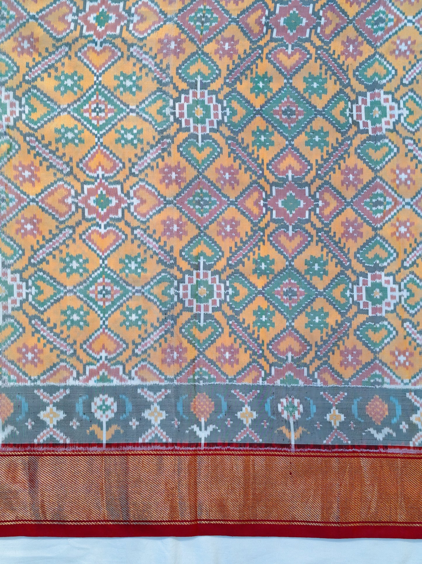 Colorful ikat silk handwoven fabric with heart patterns and zari border