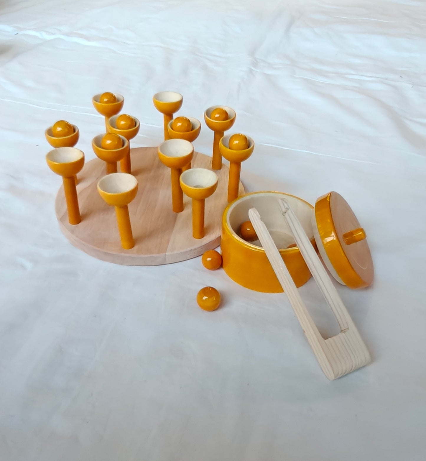 Wooden ball picking game with 12 balls, base, 12 cups, tong and a container
