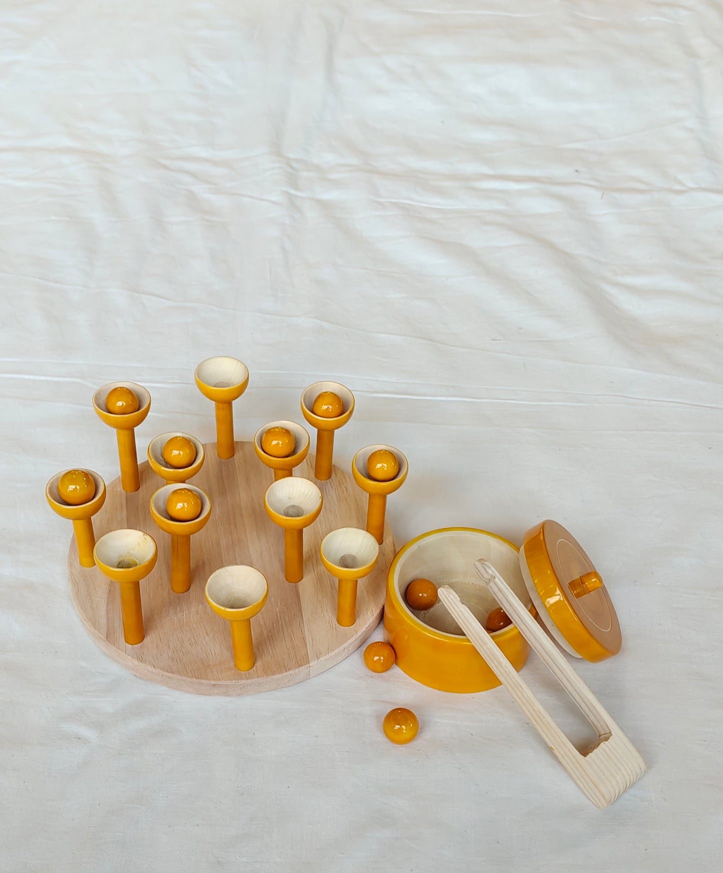 Wooden ball picking game with 12 balls, base, 12 cups, tong and a container