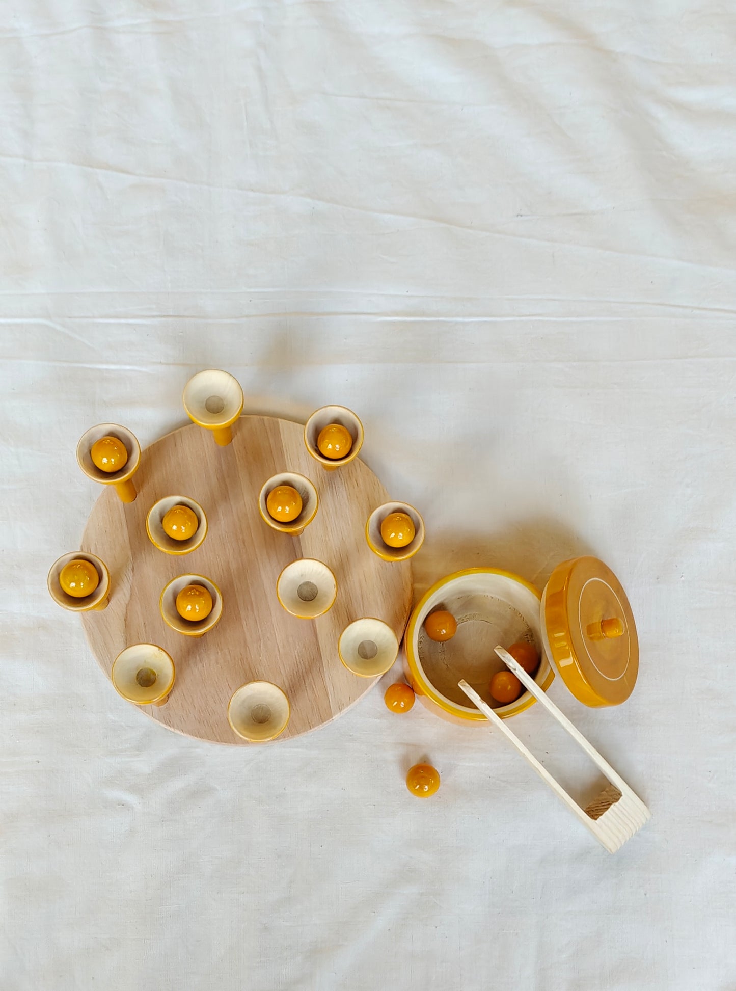 Wooden ball picking game with 12 balls, base, 12 cups, tong and a container