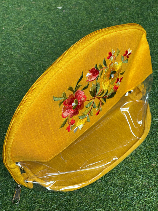 Yellow embroidered transparent toiletries / gifting pouch with zipper closure