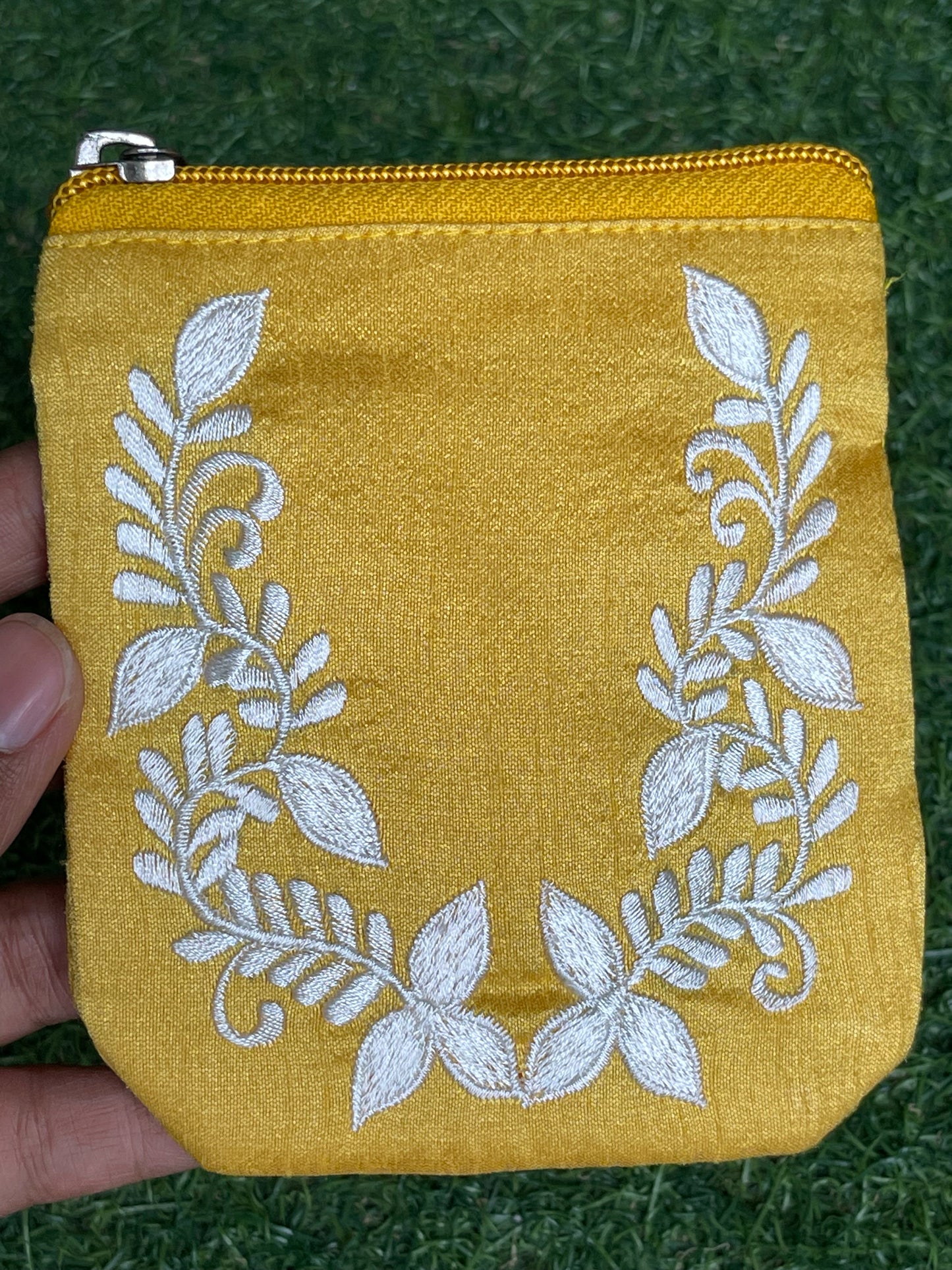Yellow embroidered fabric based gifting / coin pouch with zipper closure