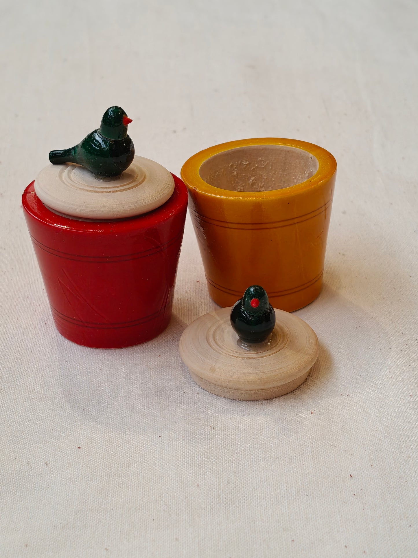 Wooden handcrafted haldi kumkum containers with a parrot on lid