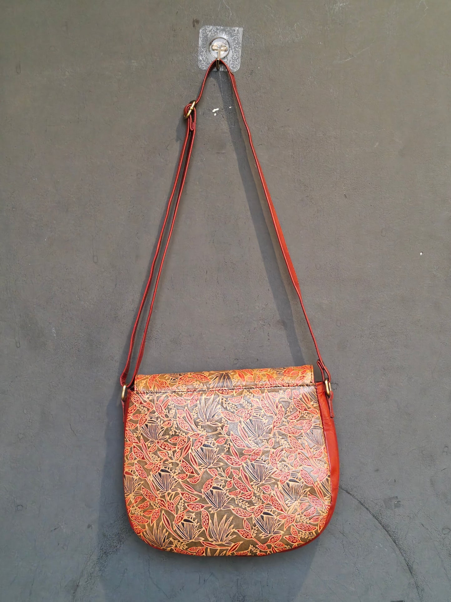Leather hand crafted, hand painted adjustable length sling bag with metal clasp