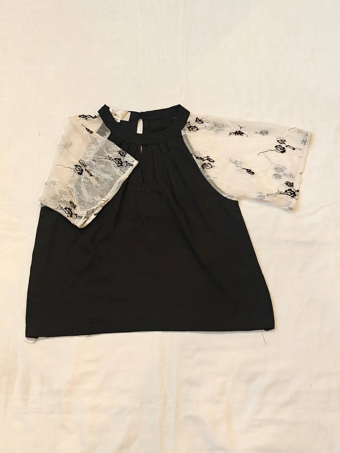 Black top with white lace sleeves