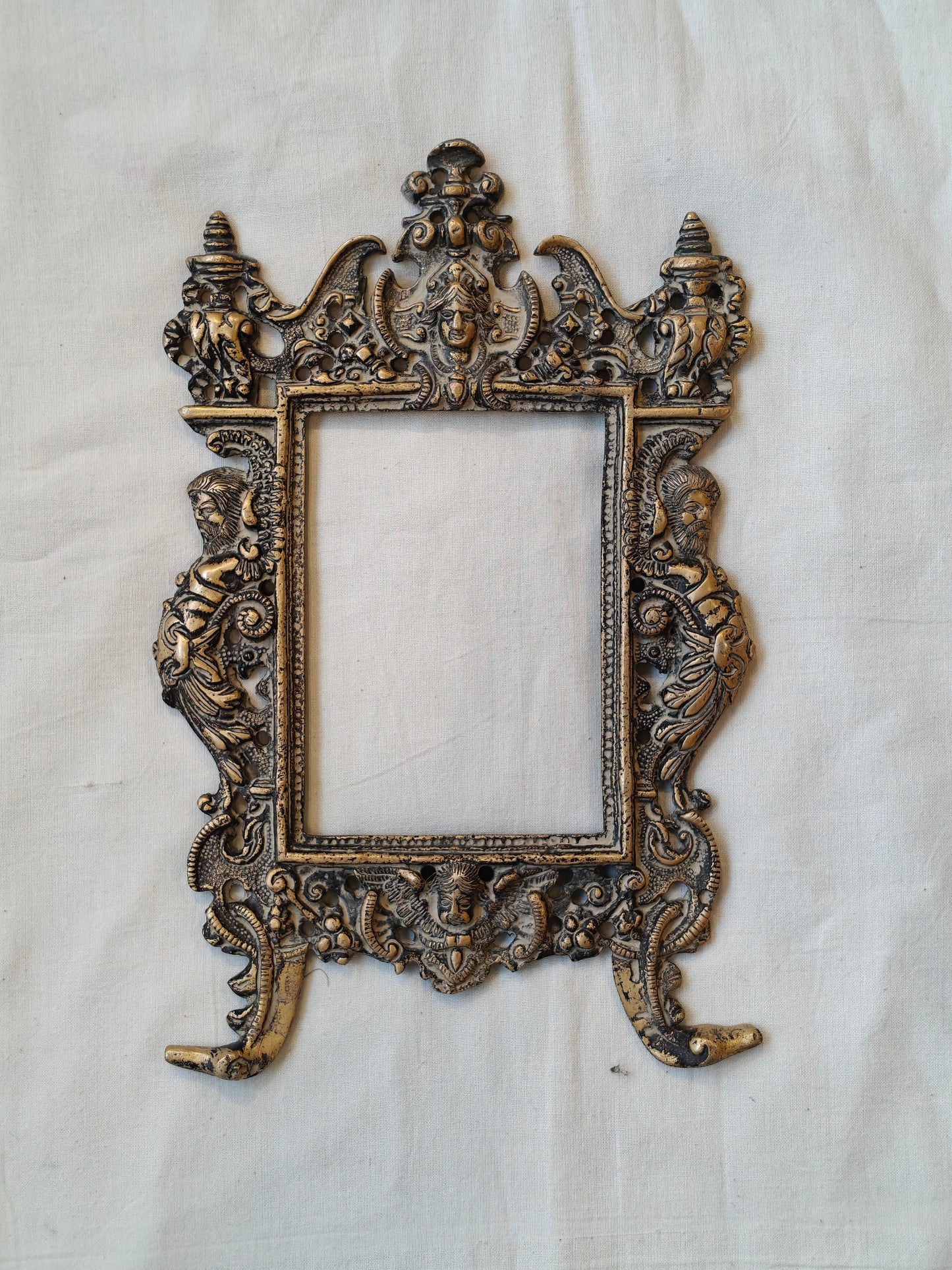 Vintage brass handcrafted wall frame with mythological carvings