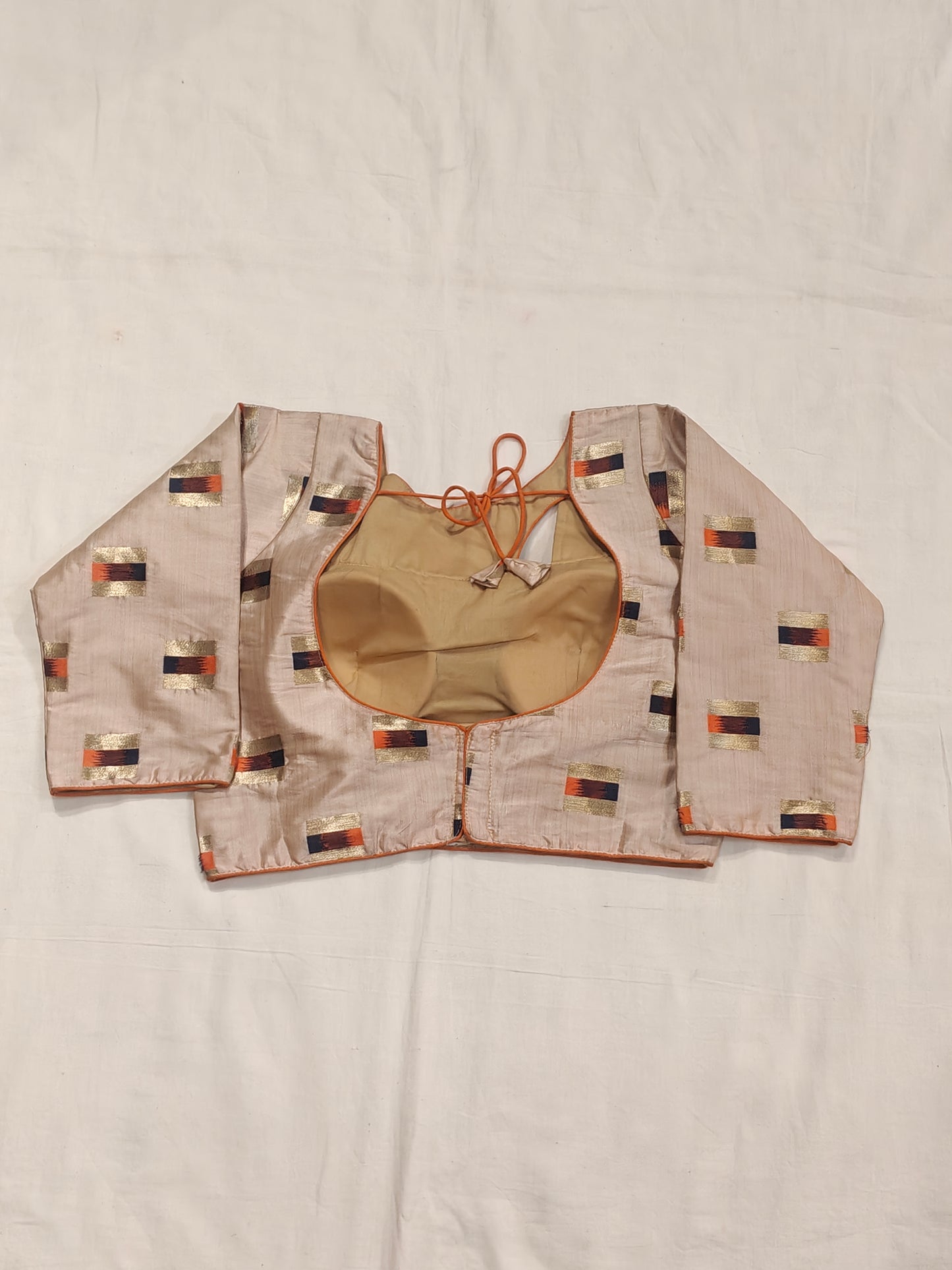 Gold orange design on cream base blouse with fancy neck cut