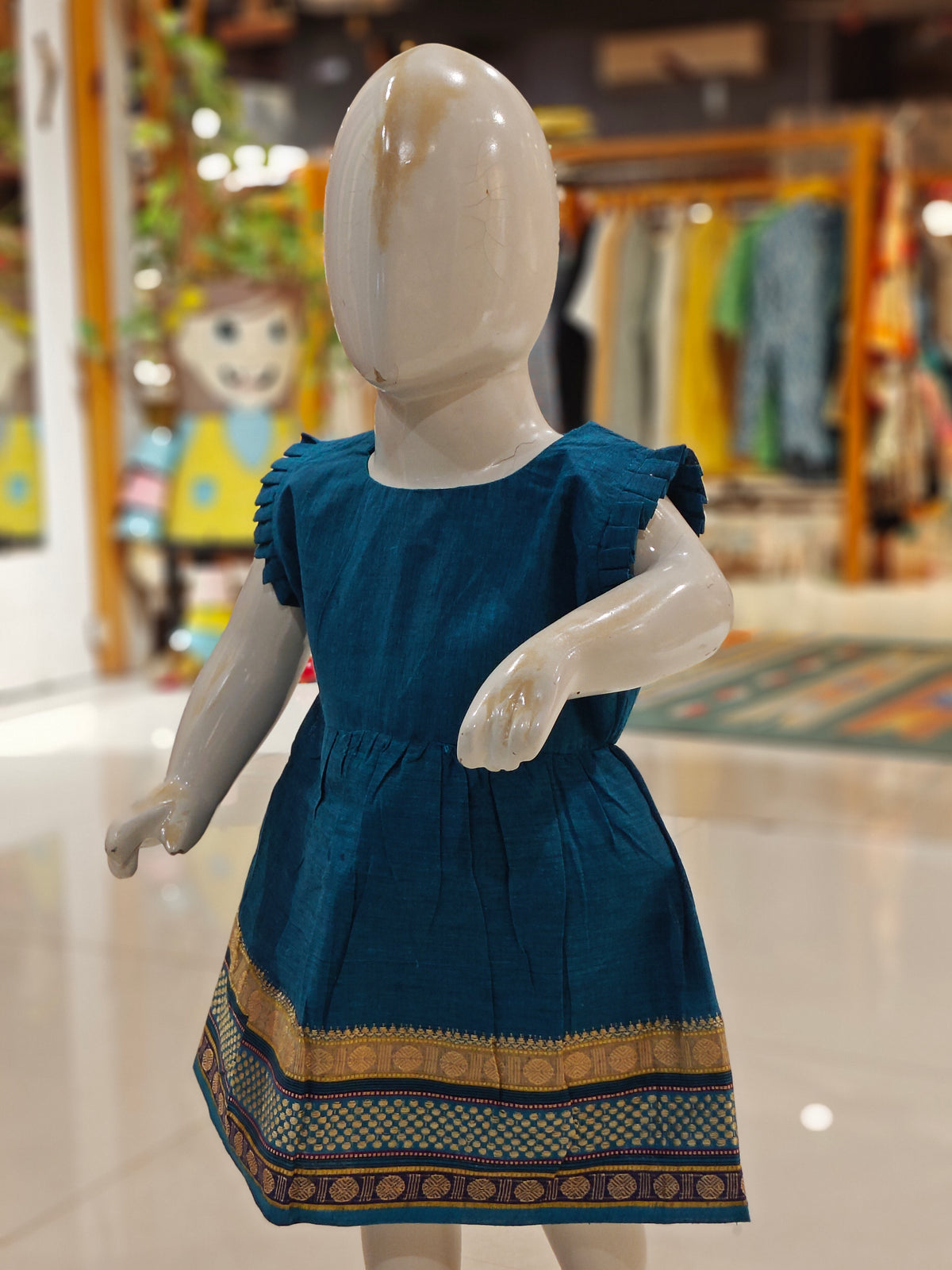Blue ethnic cotton frock for girls with colorful border at hem