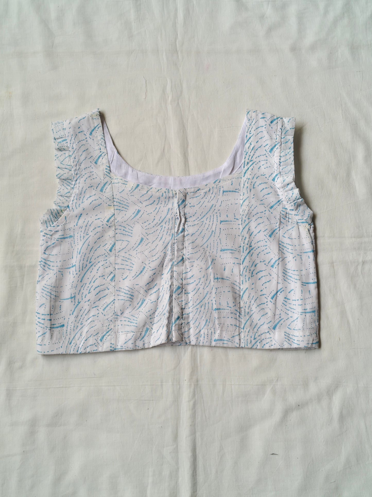 Blue hand block printed design on white cotton sleeveless blouse