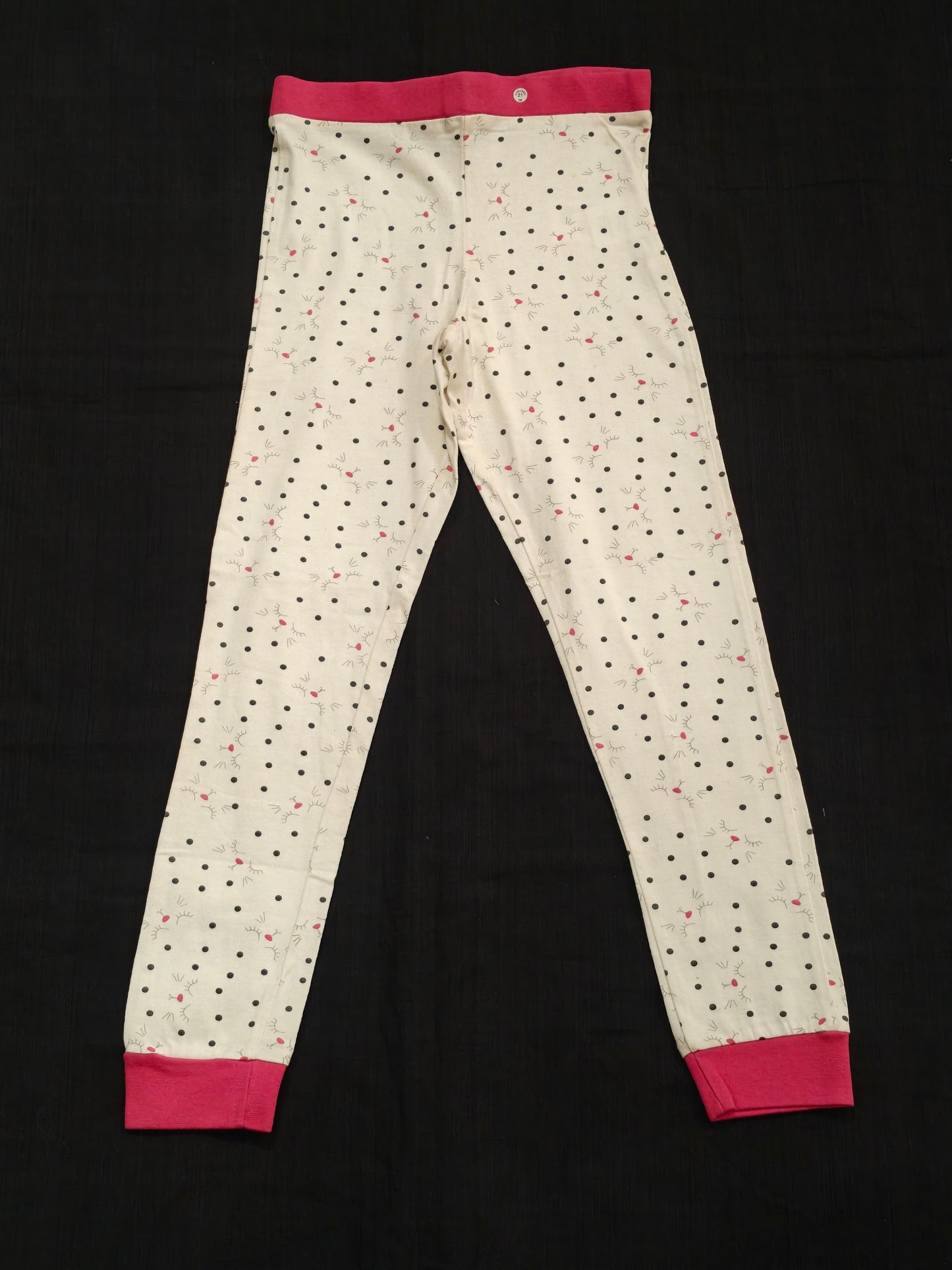 White leggings with polka dots and pink elastic cuffs and waistband