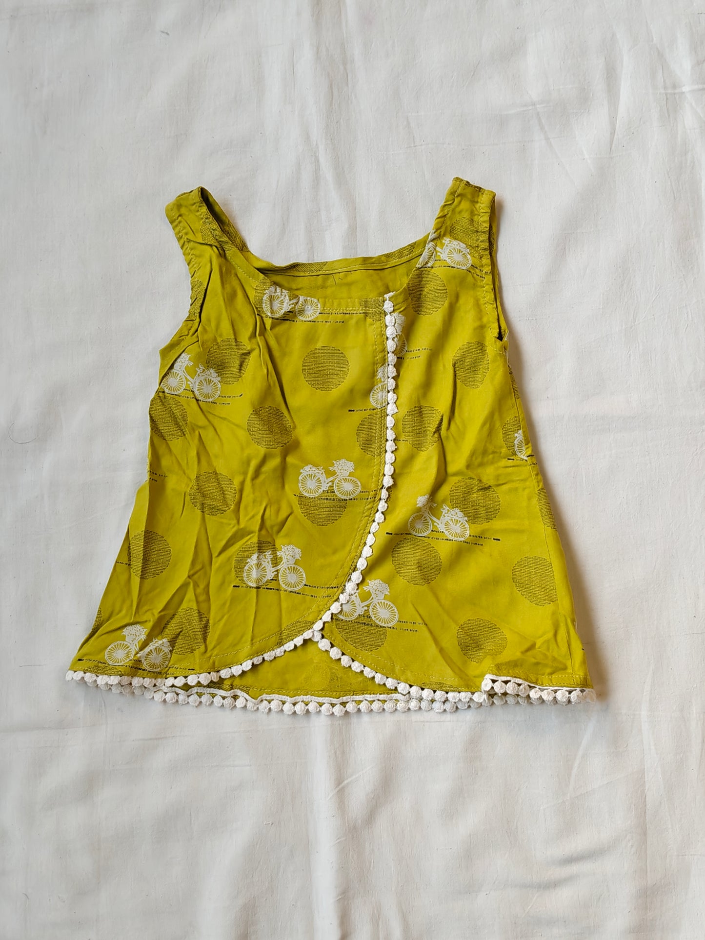Green overlap front panels top with pom pom trims