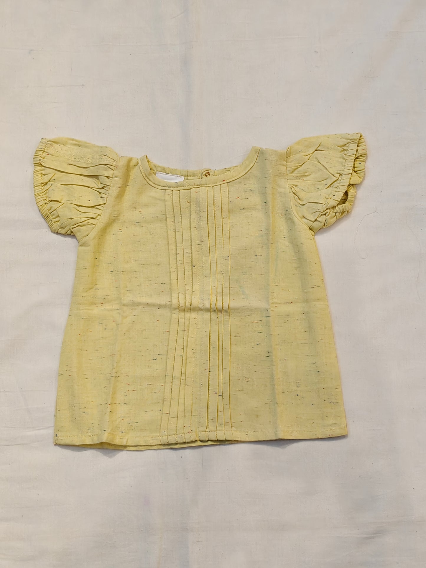 Light yellow top with fluttered sleeves and pintucks