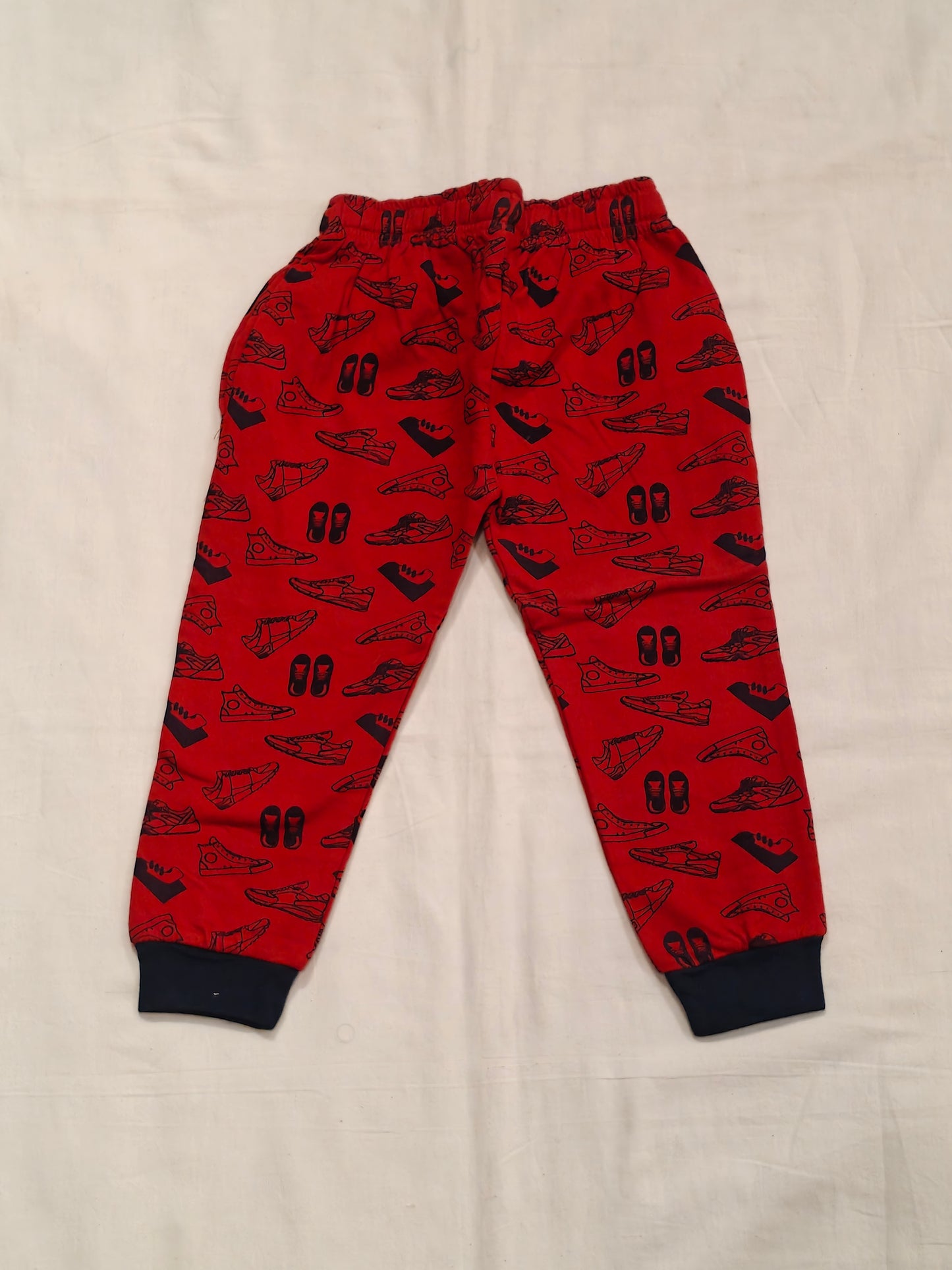 Red cotton jogger pants with shoes print for children