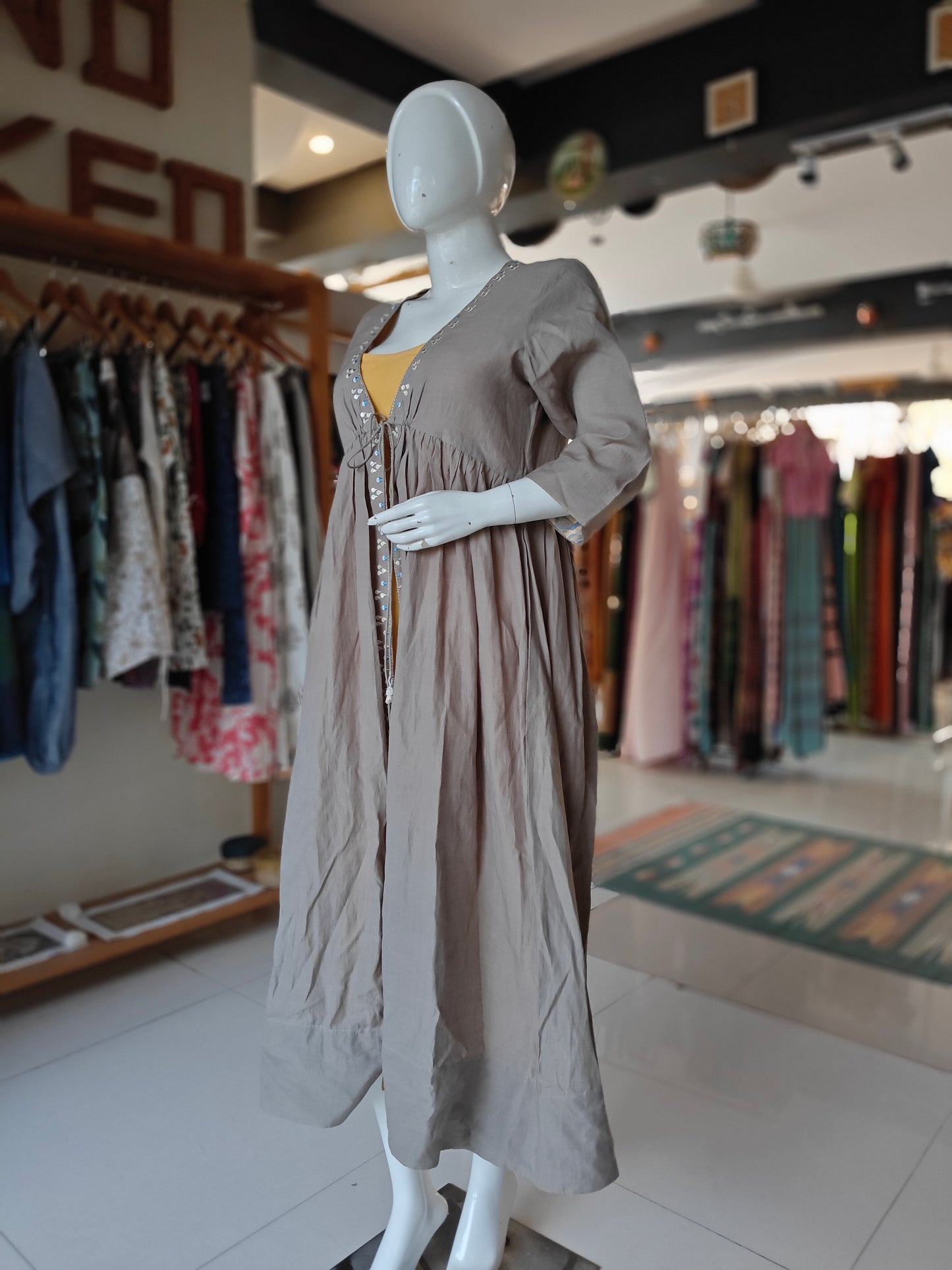 Plain yellow kurti with light grey brown embroidered jacket
