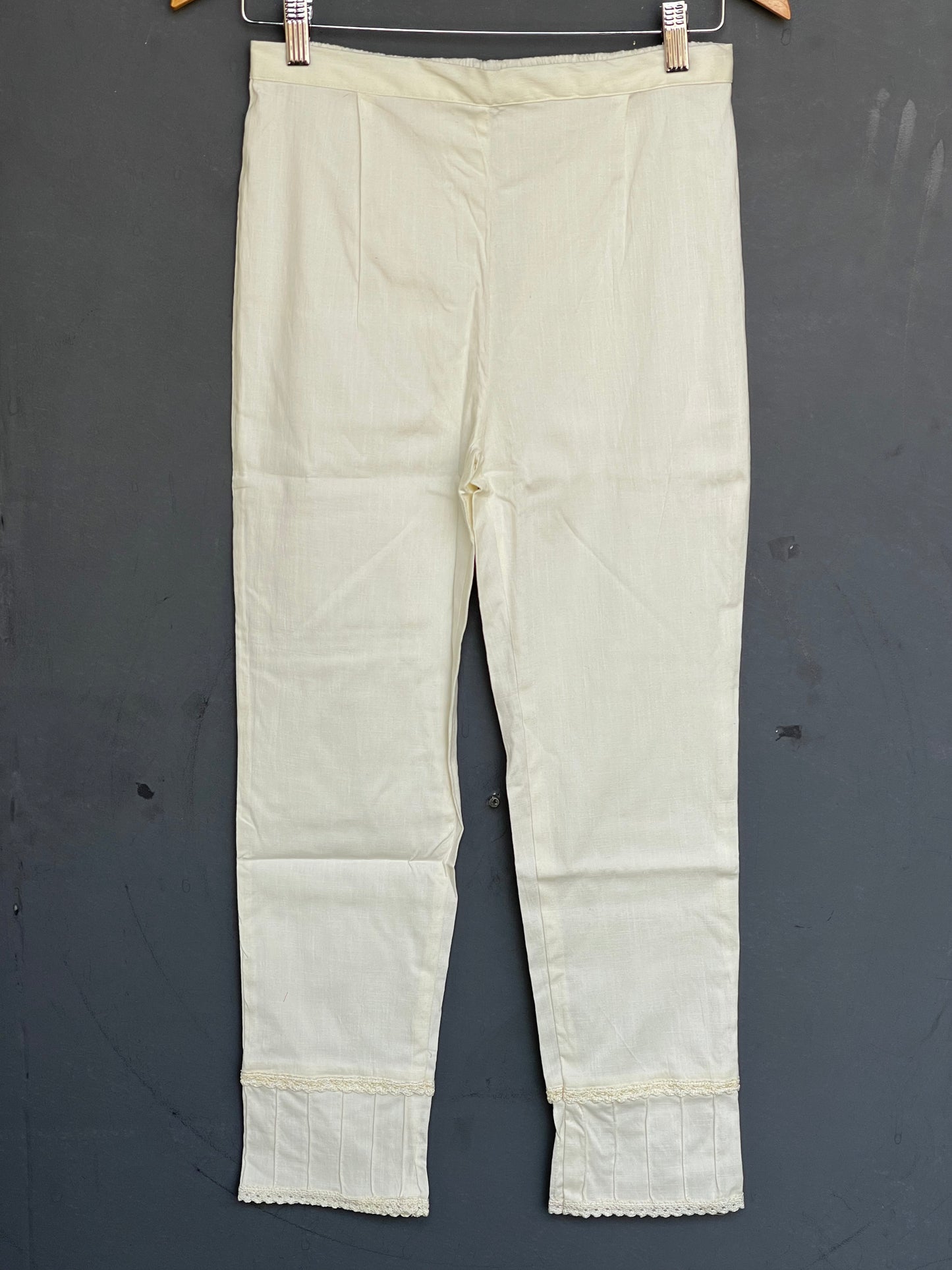 Cream Cotton Lycra pants with lace and pin-tucks detailing for hem