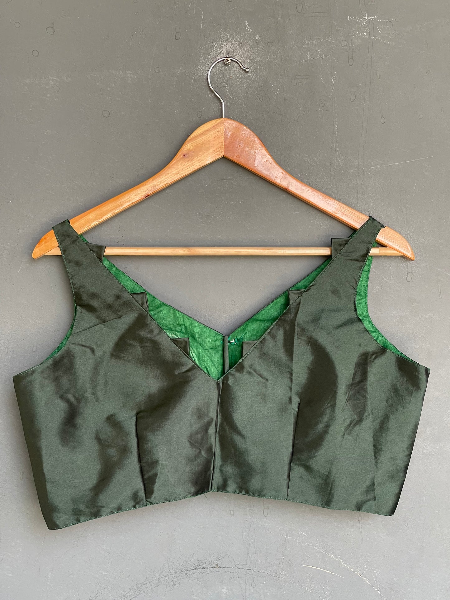 Dark green V neck art silk padded sleeveless blouse
