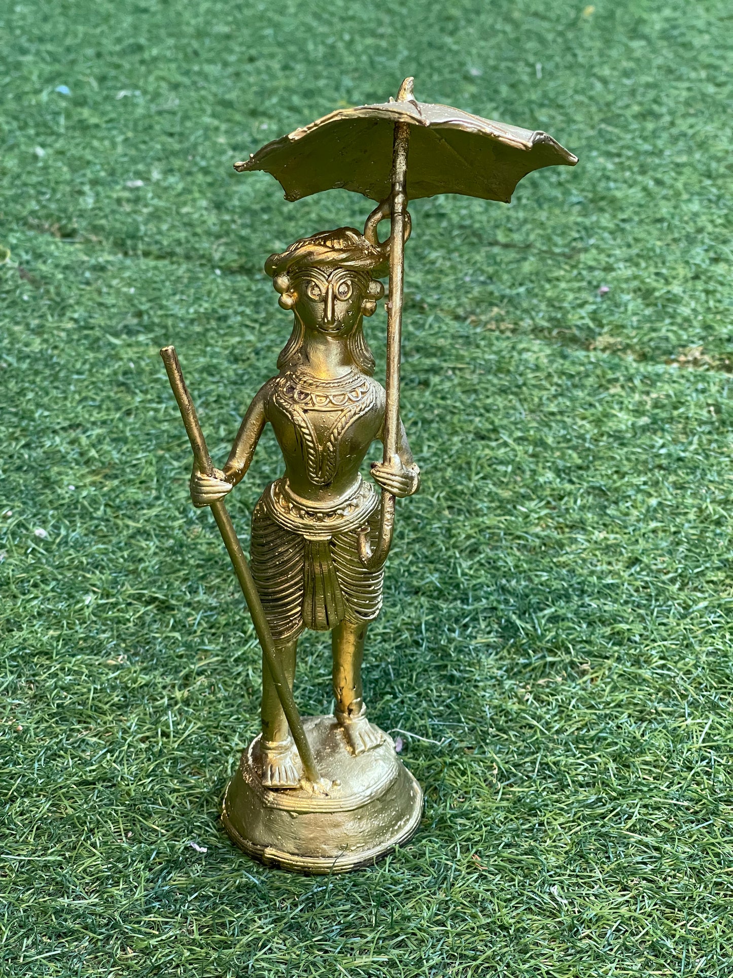 Dokra craft brass person with an umbrella