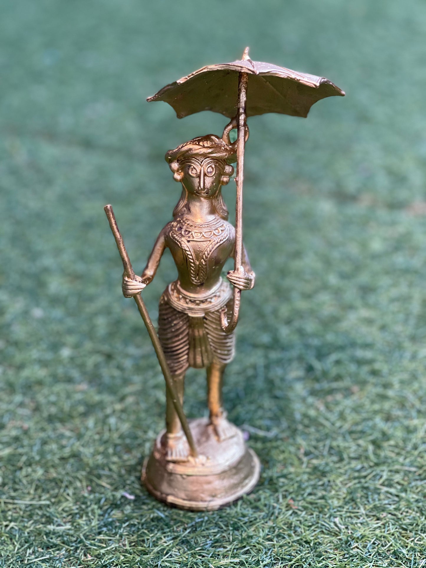 Dokra craft brass person with an umbrella