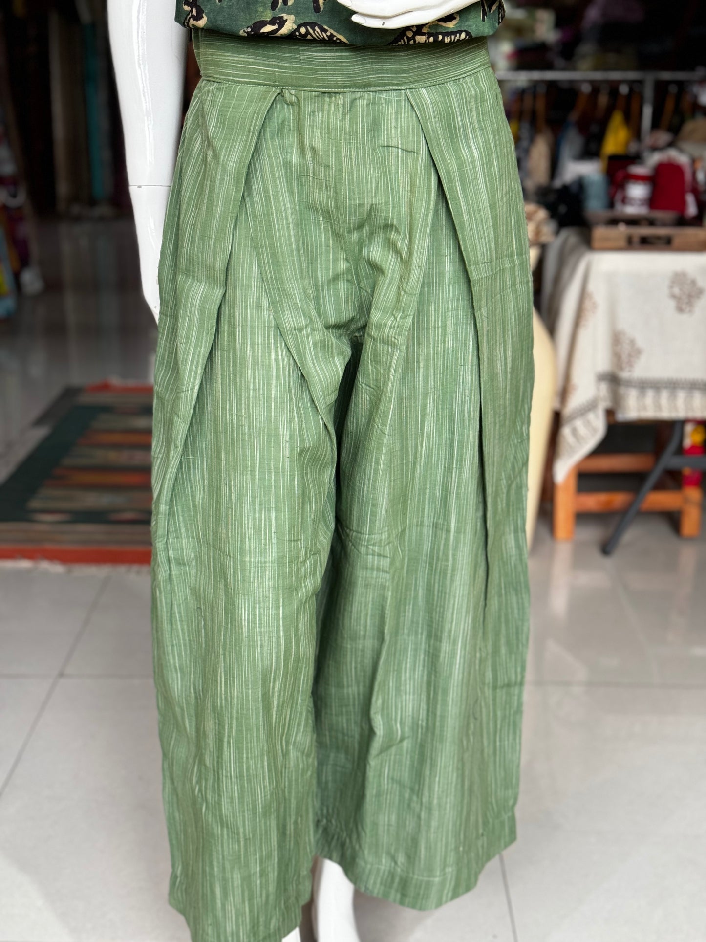 Green handloom cotton flared pants with pleats at waist detailing