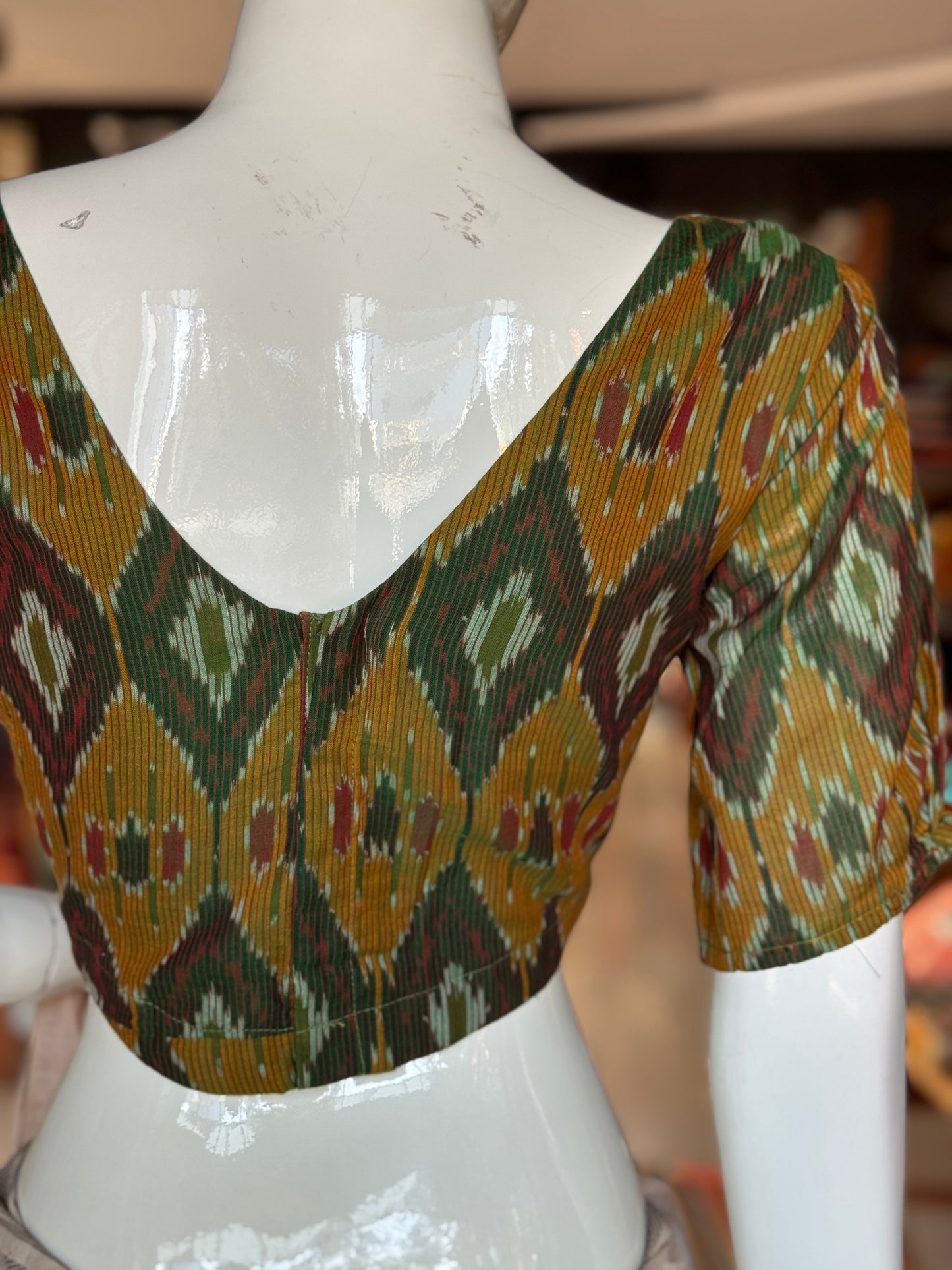 Dark green Ikat cotton blouse with curved waist line