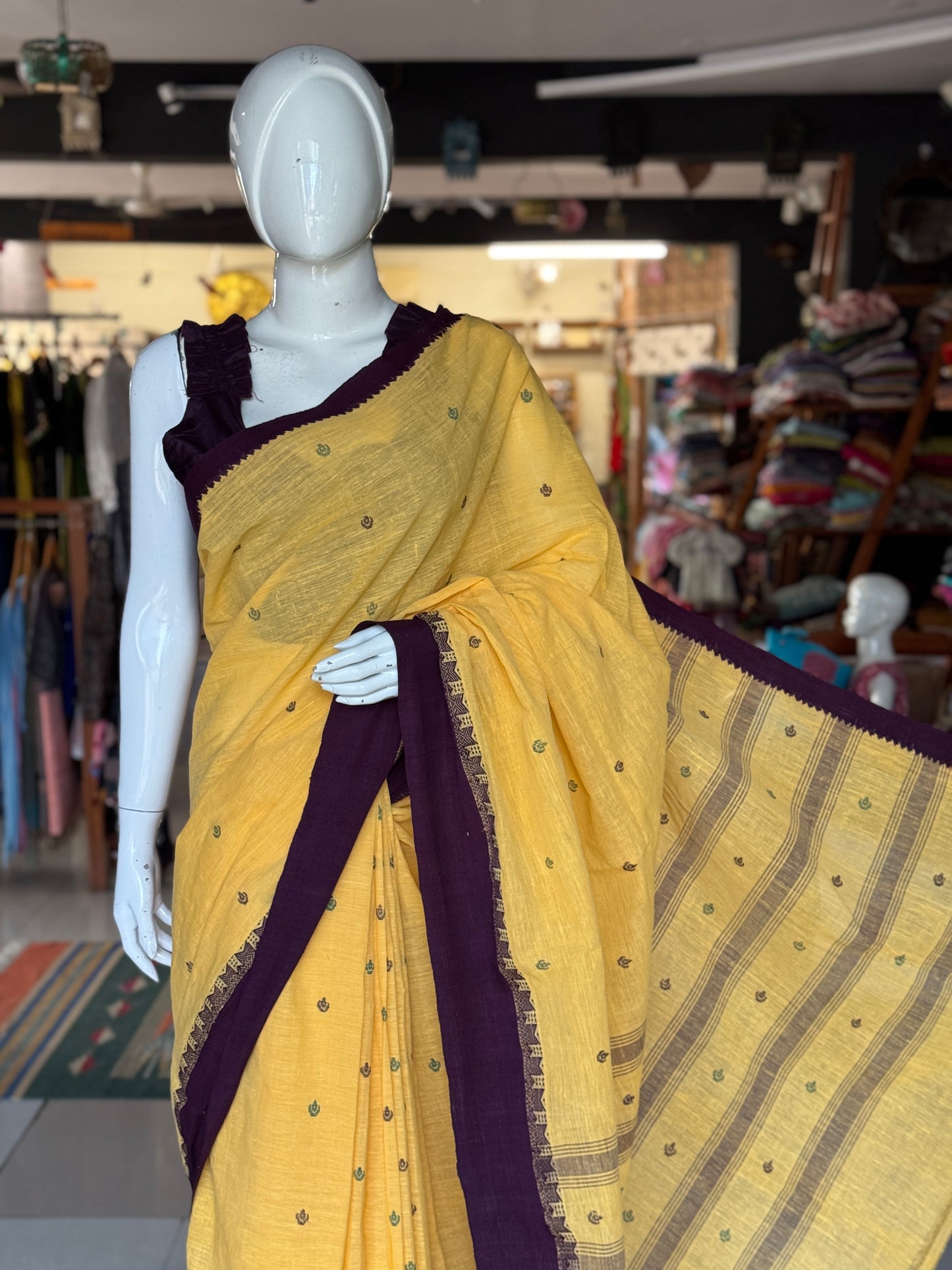 Yellow coarse textured handloom cotton saree with small butis and purple Kuppadam border