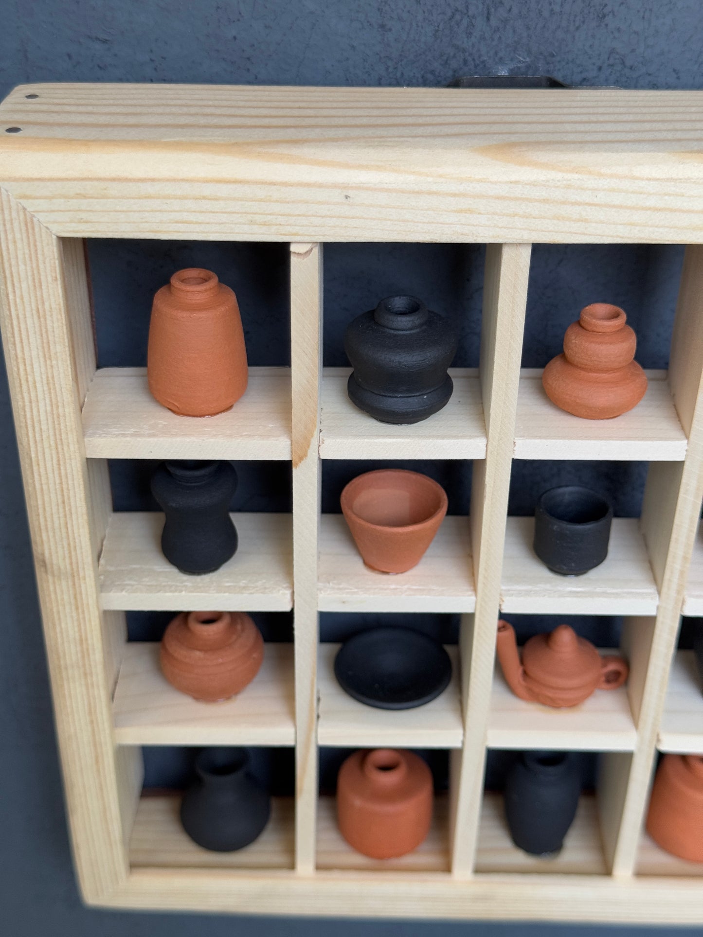 Miniature handcrafted clay pots in a wooden shelf - 6 x 6 inch frame size