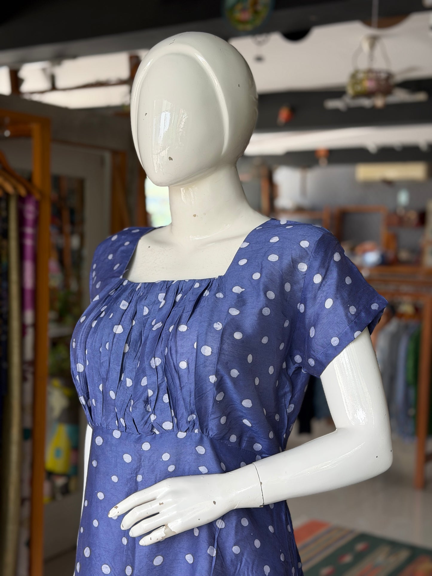 Blue polka dots dress with square neckline and gathered bust