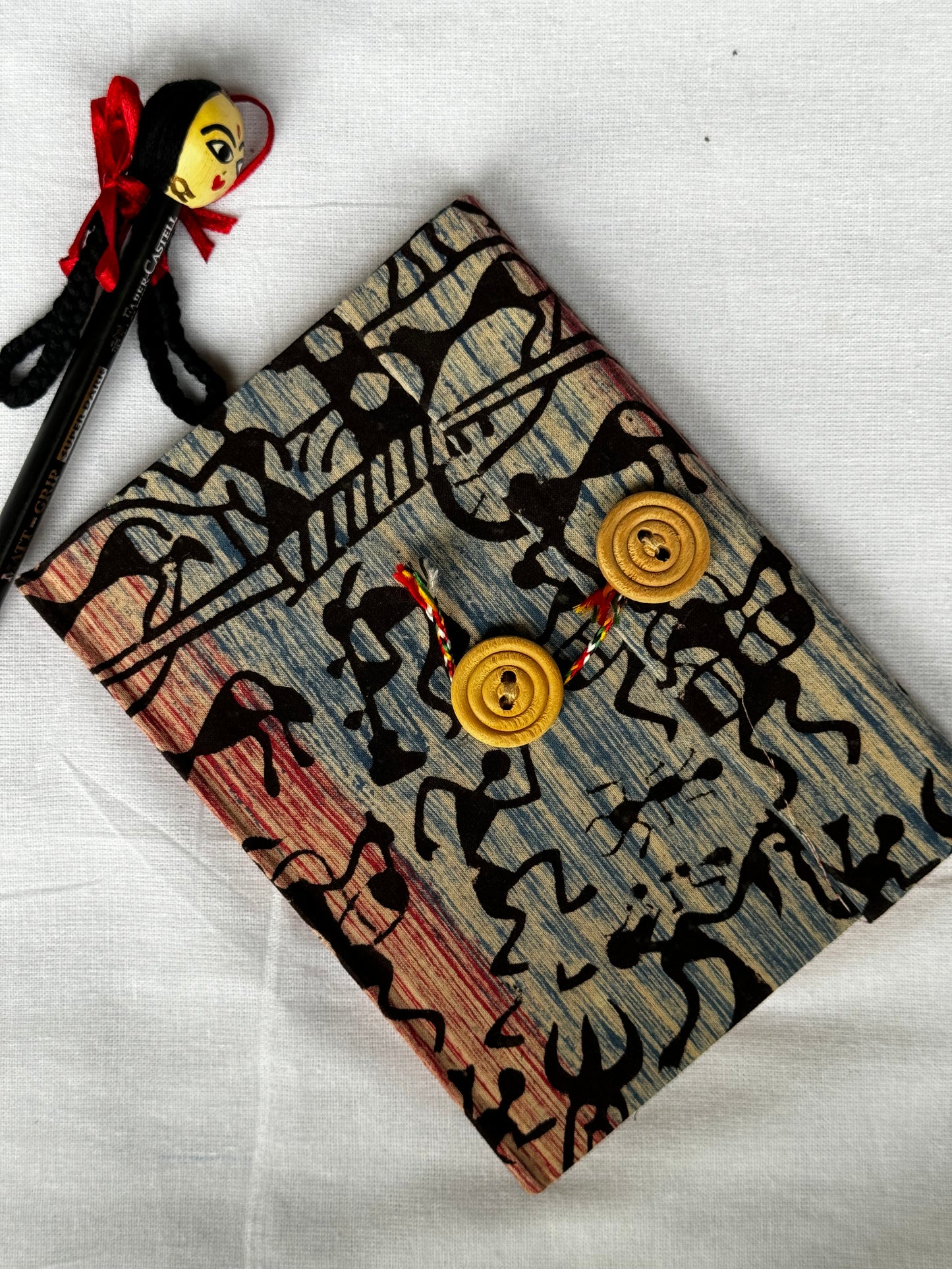 Pocket notebook with fabric cover with button and thread closure