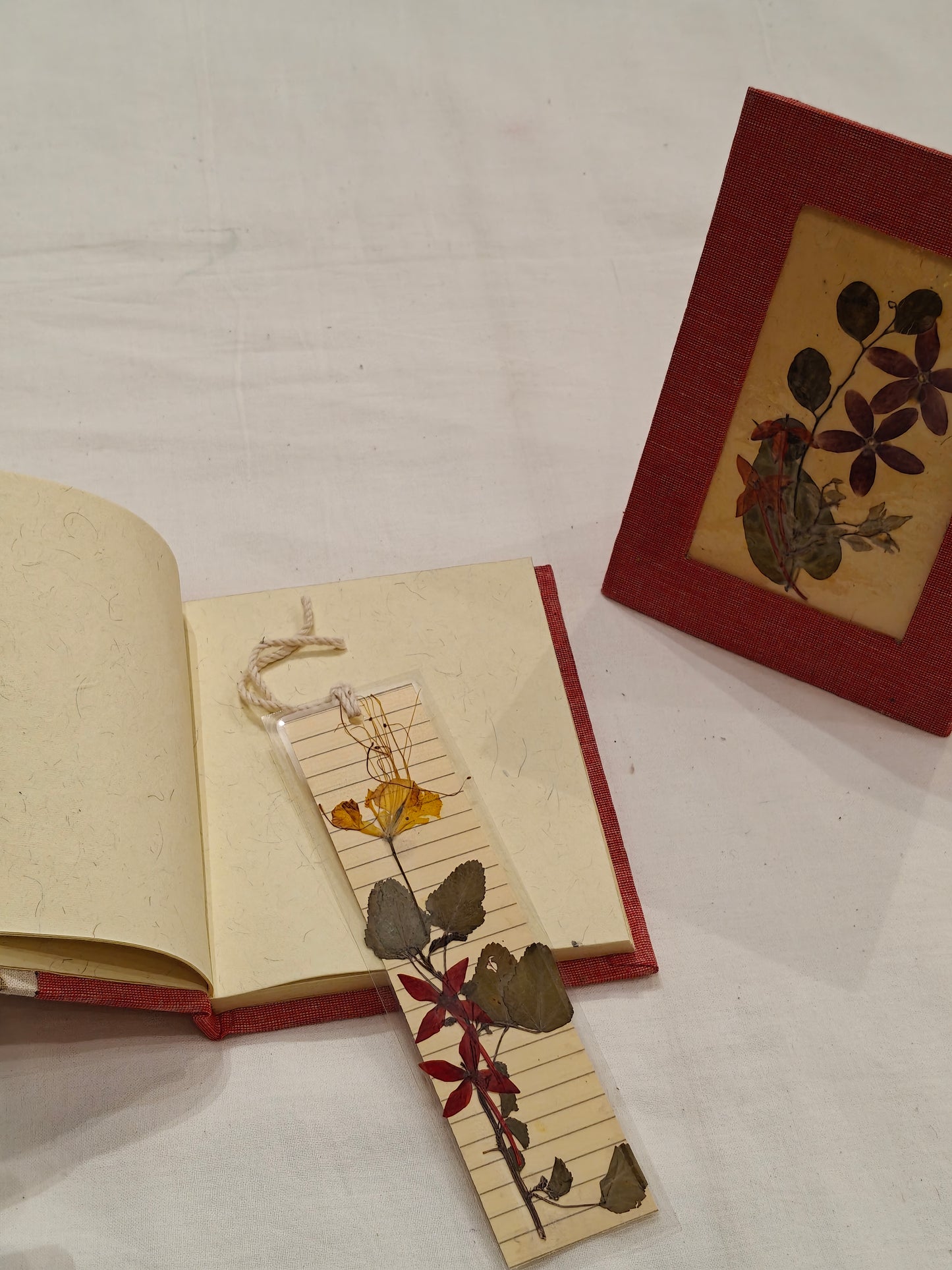 Handmade paper notebook with eco leaf printed fabric cover, hand crafted bookmark with dried flowers and a table frame pouch set