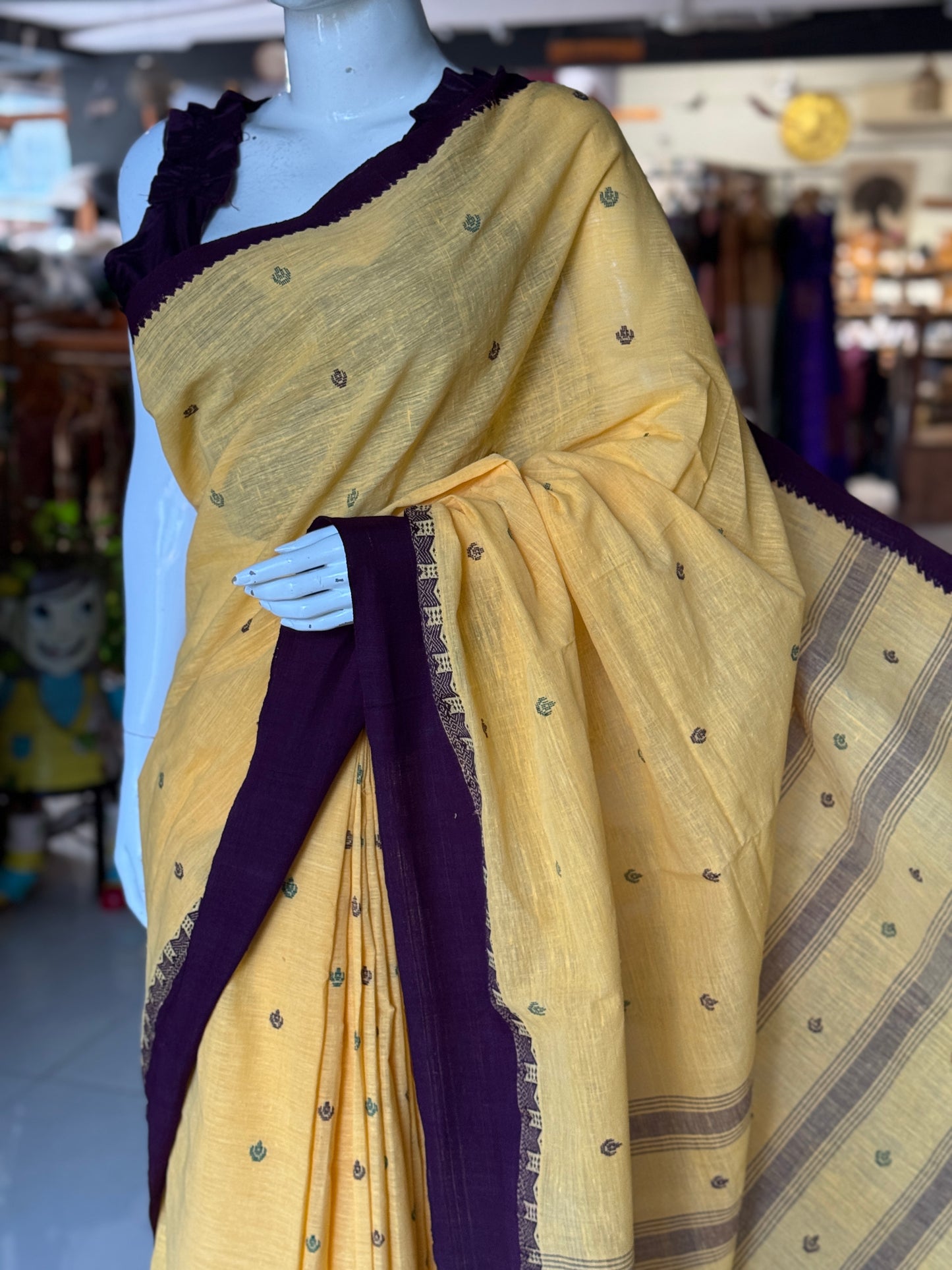 Yellow coarse textured handloom cotton saree with small butis and purple Kuppadam border