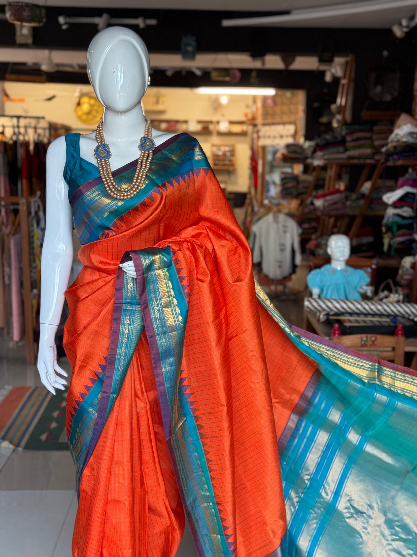 Gold spot orange and blue checks pure silk handwoven Gadwal saree with kuttu temple border