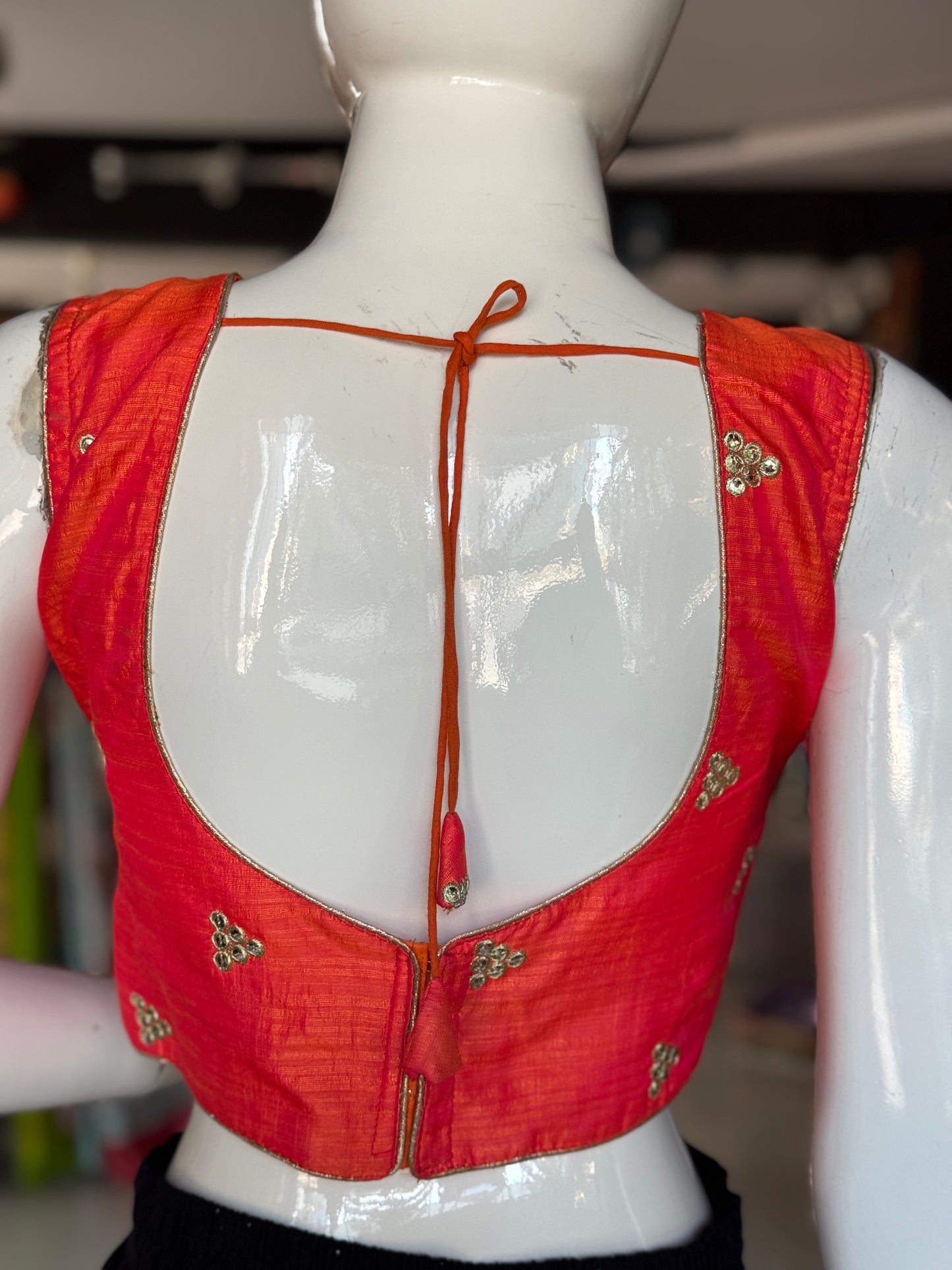 Orange embroidered sleeveless blouse with deep back