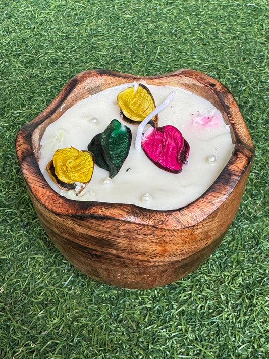 Candle in a flower shaped wooden bowl