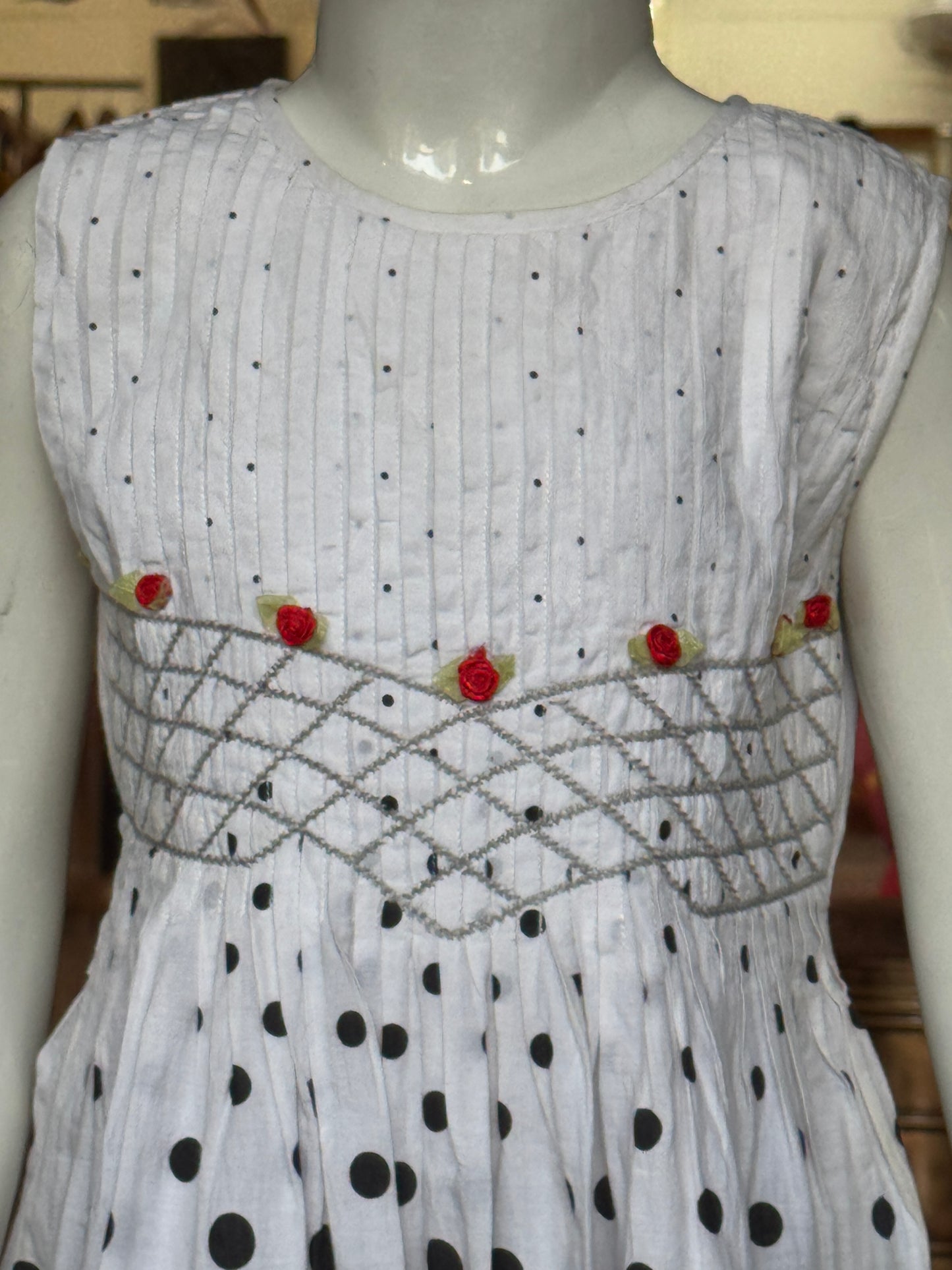 Black varying sized dots on white smocking cotton frock with hand embroidery and lace trims