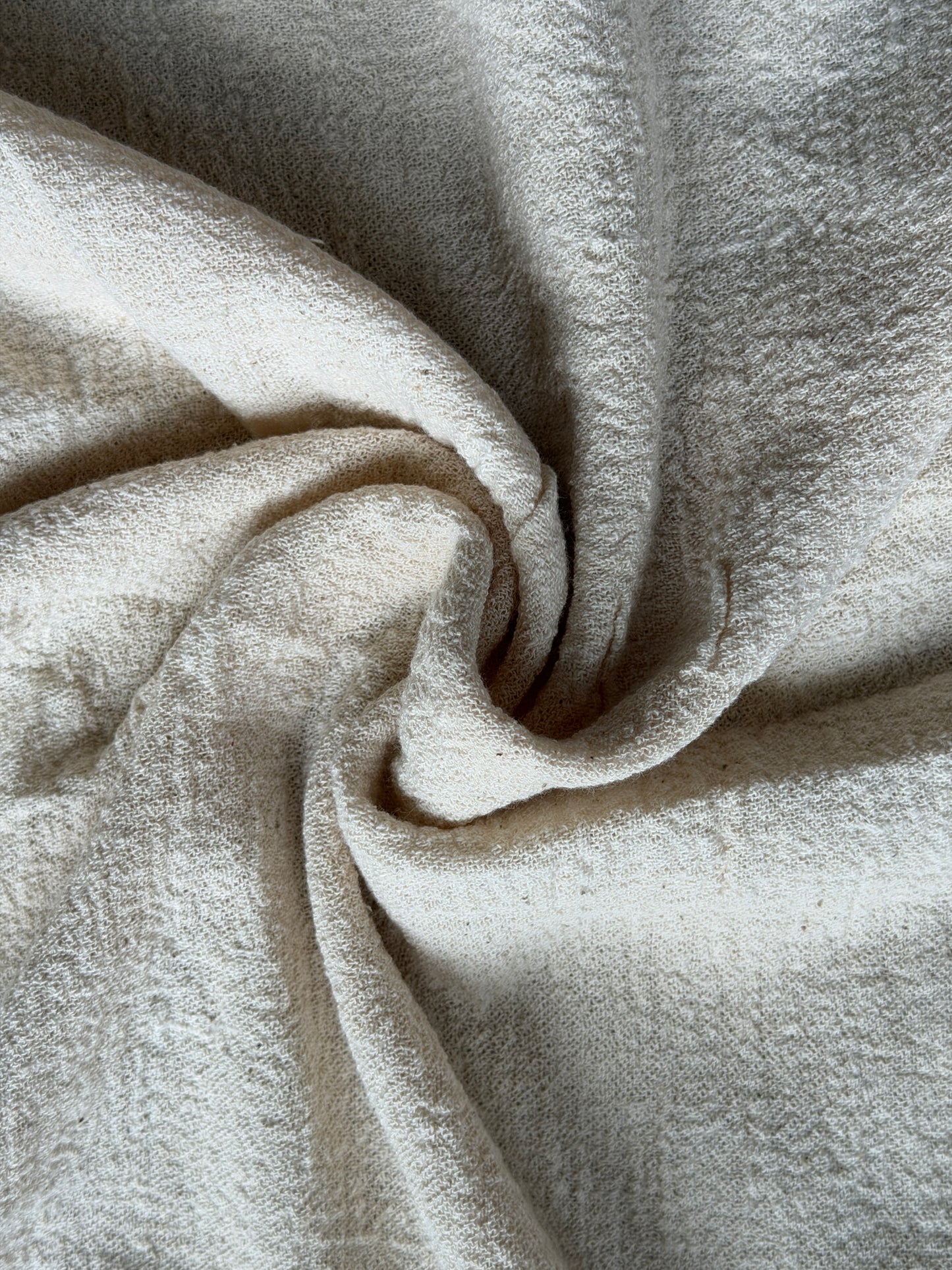 Off white cotton hand spun, hand woven fabric with textured stretch style weave