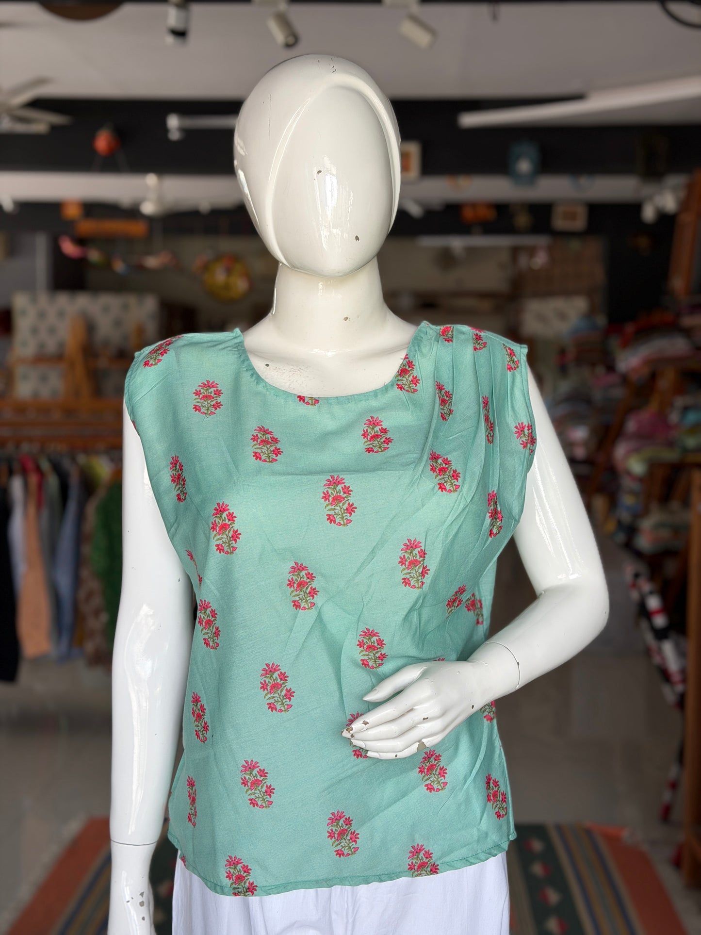 Green floral print top with asymmetric pleats on shoulder