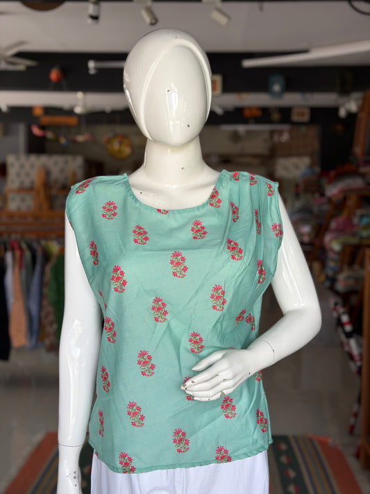 Green floral print top with asymmetric pleats on shoulder