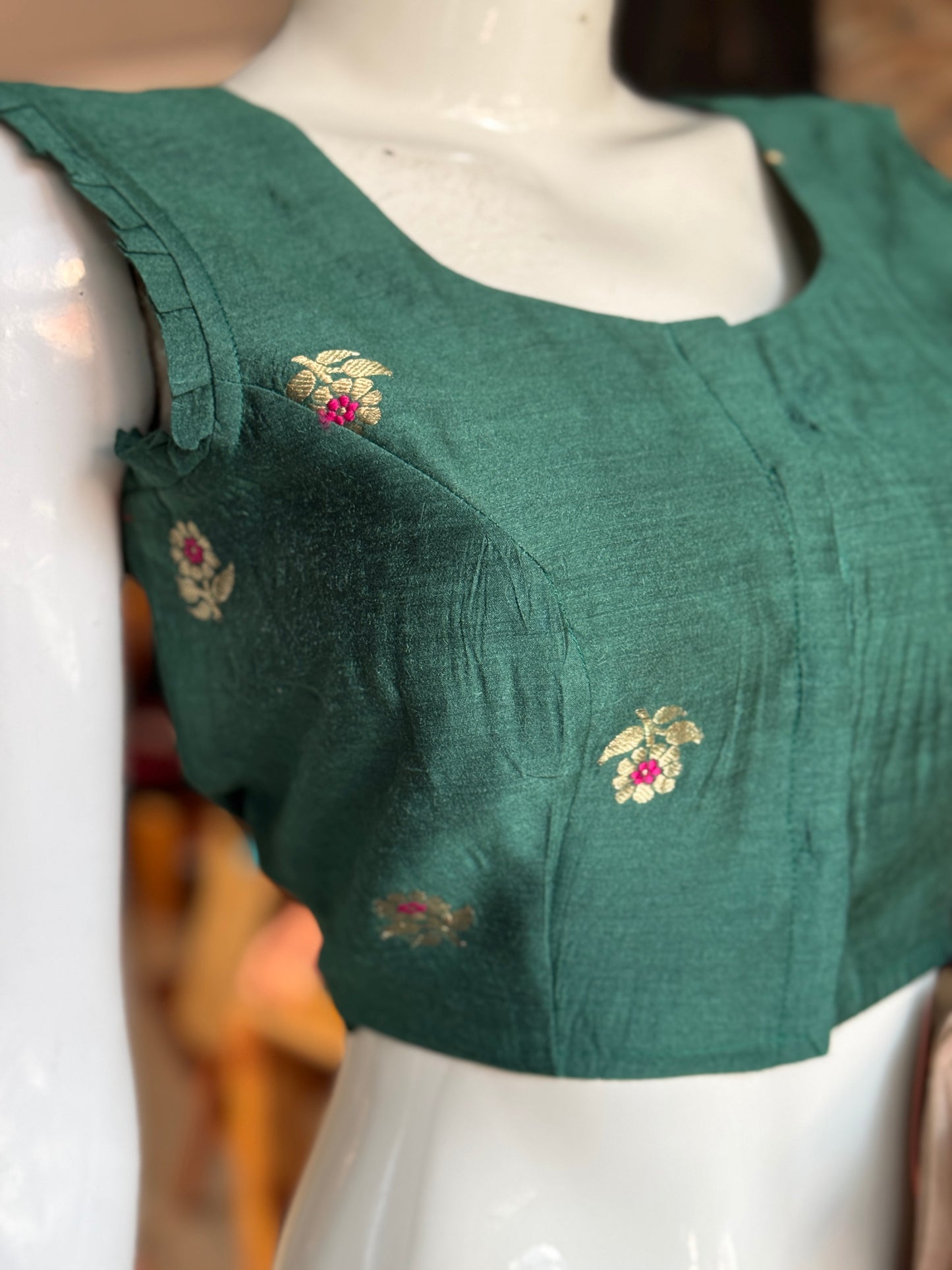 Teal green moonga silk handwoven blouse with floral motifs
