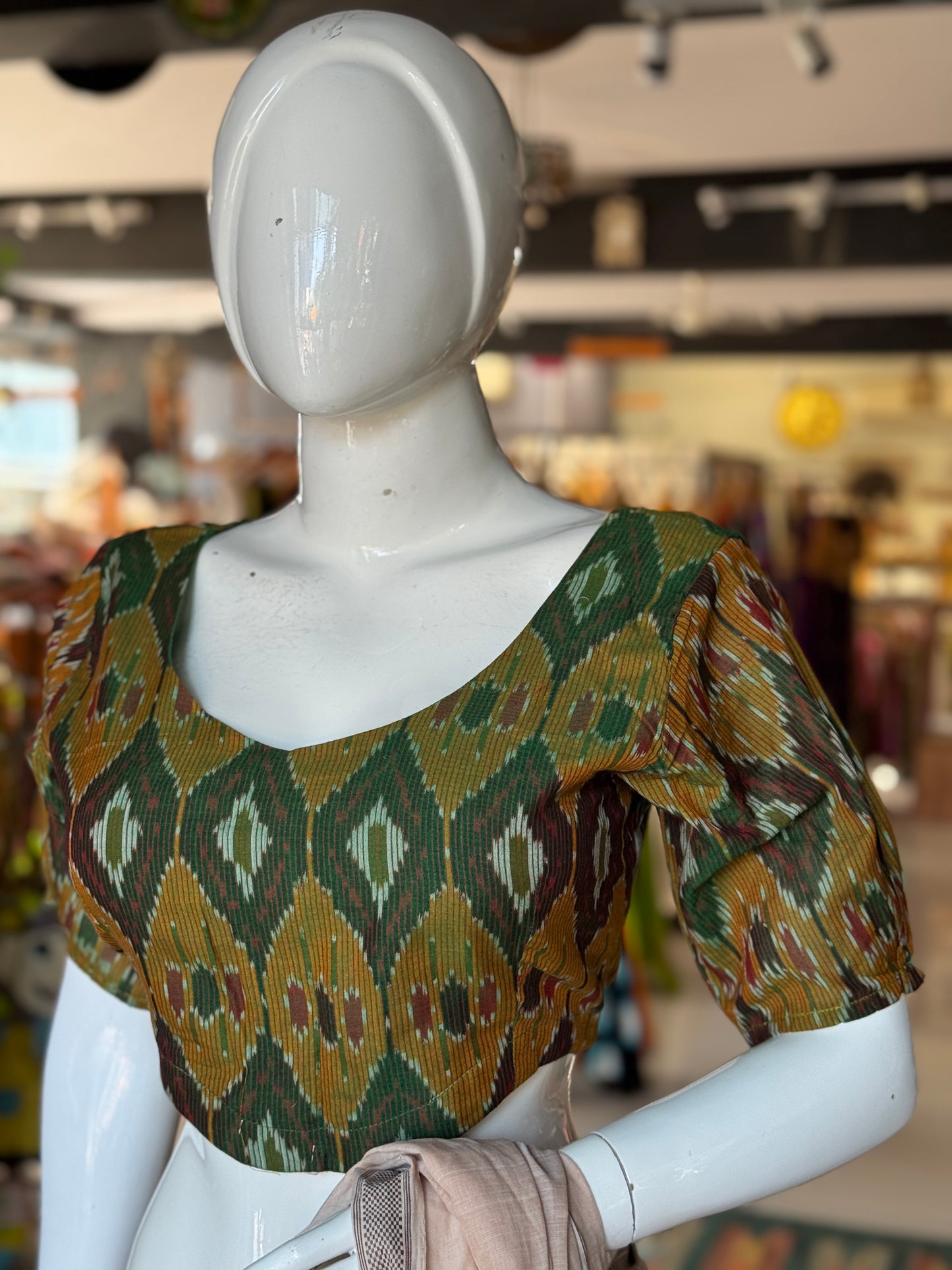Dark green Ikat cotton blouse with curved waist line
