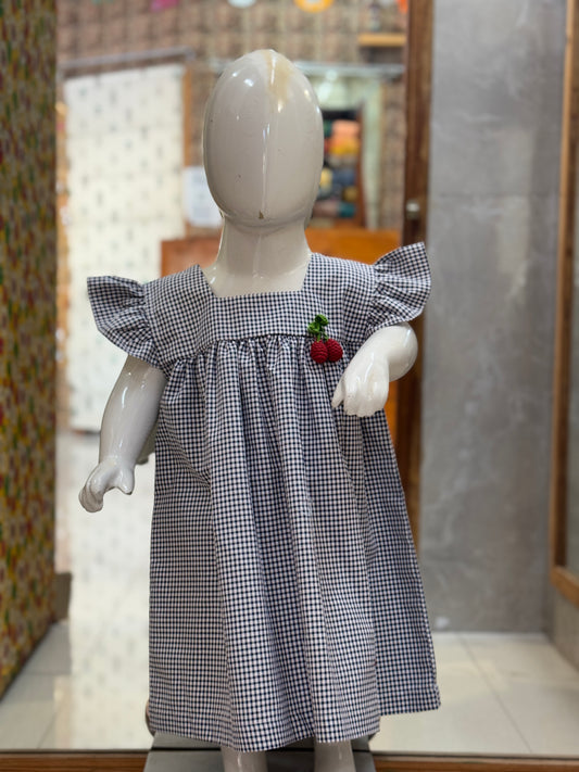 Black and white checks cotton baby frock with red cherries embroidery, crochet brooch