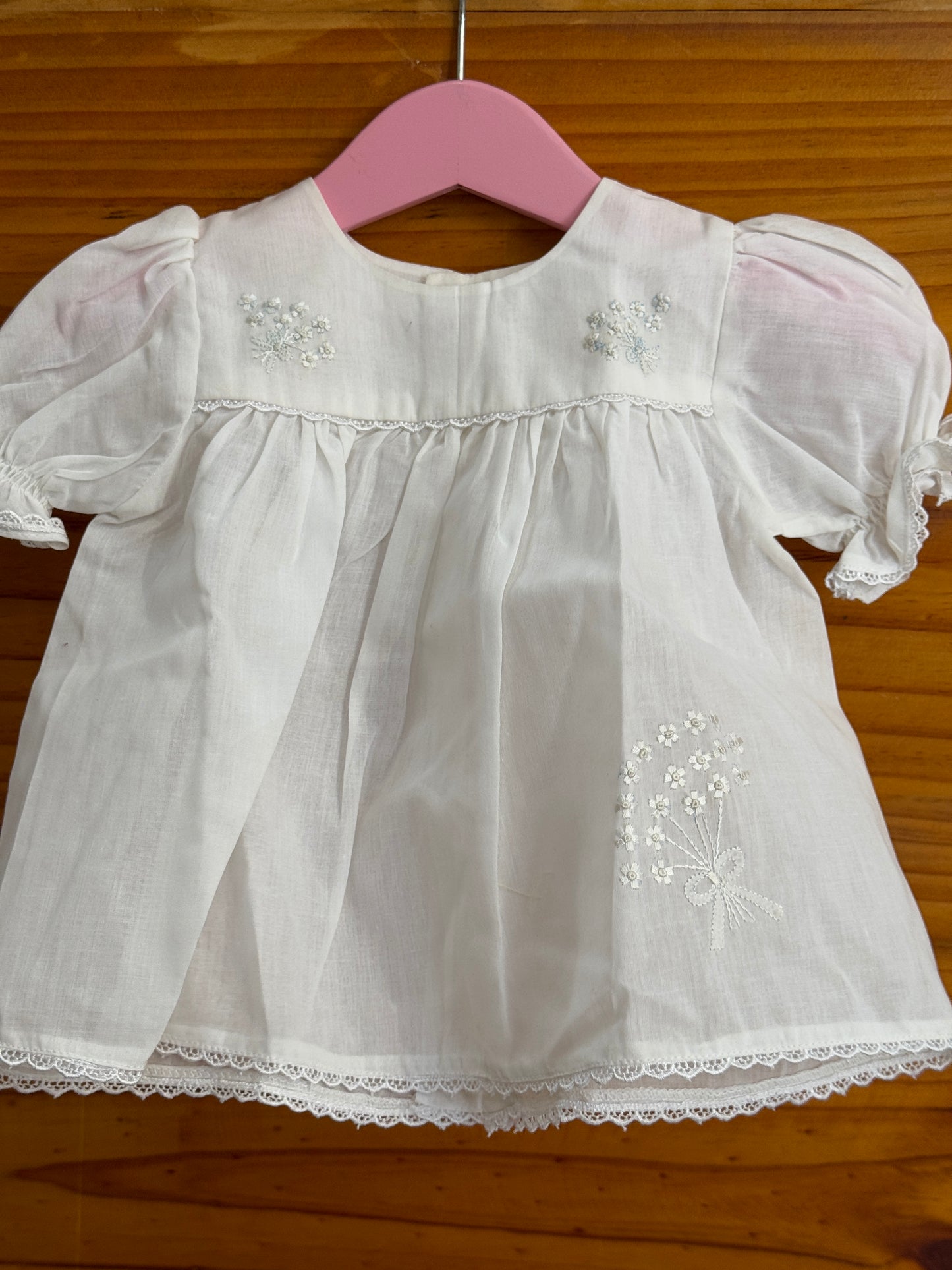 White cotton baby frock with cute flower bunch hand embroidery and lace trims