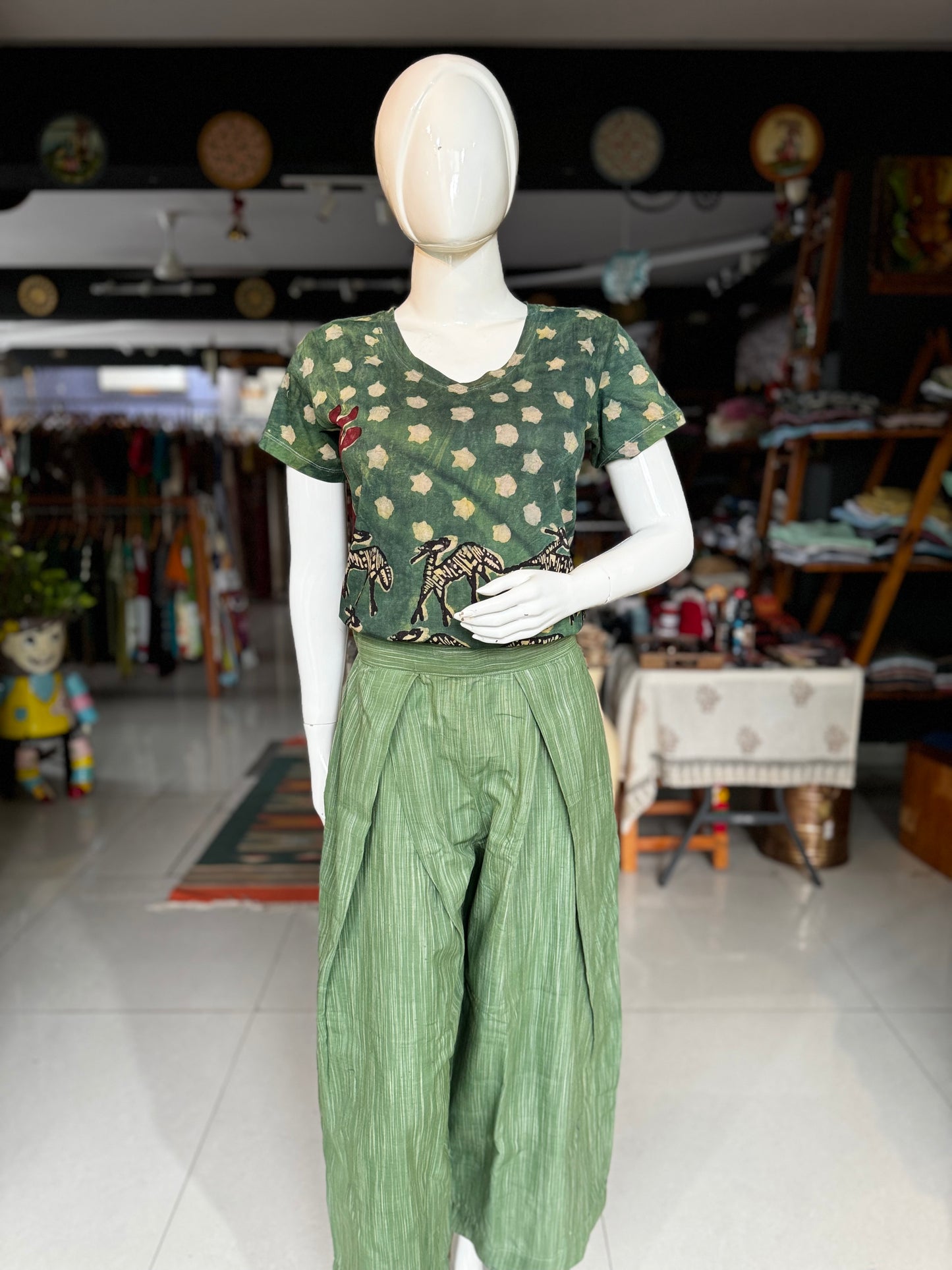 Green handloom cotton flared pants with pleats at waist detailing