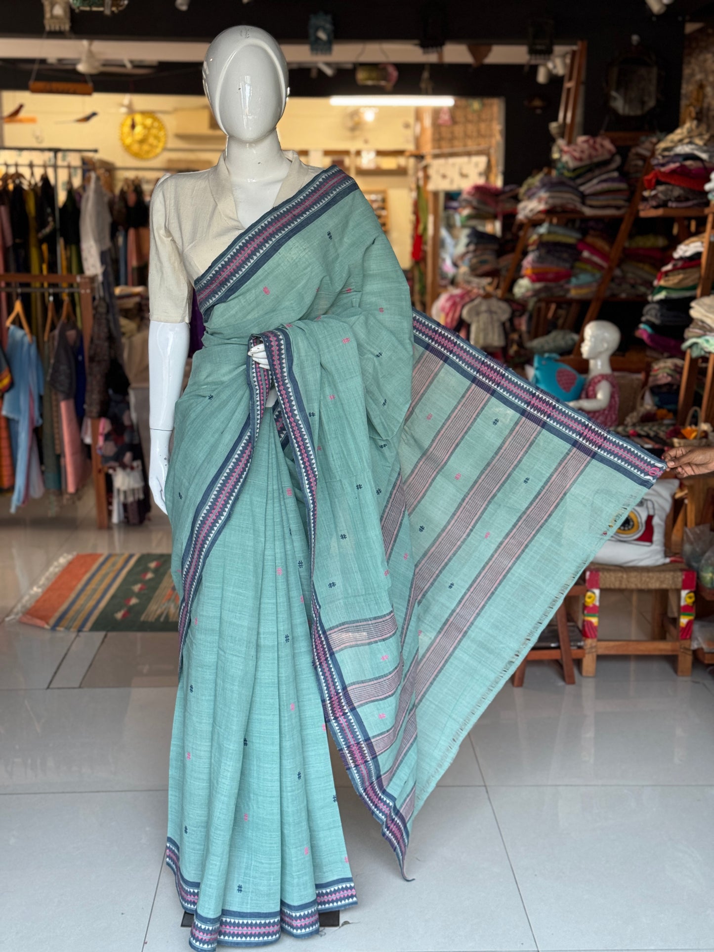 Pastel bluish green coarse textured handloom cotton saree with small butis and thread border