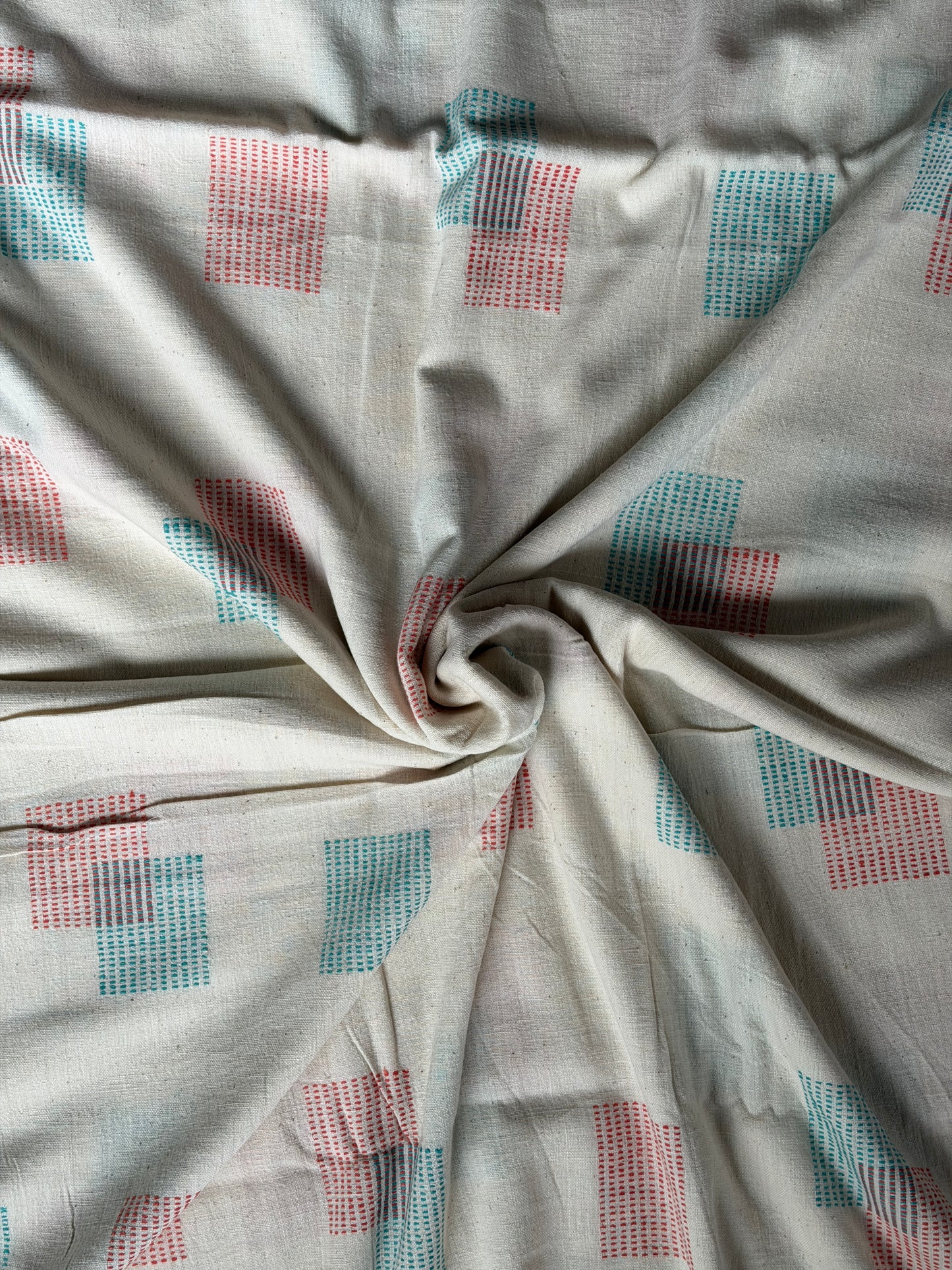 Off white cotton hand spun, hand woven fabric with orange and blue woven rectangles