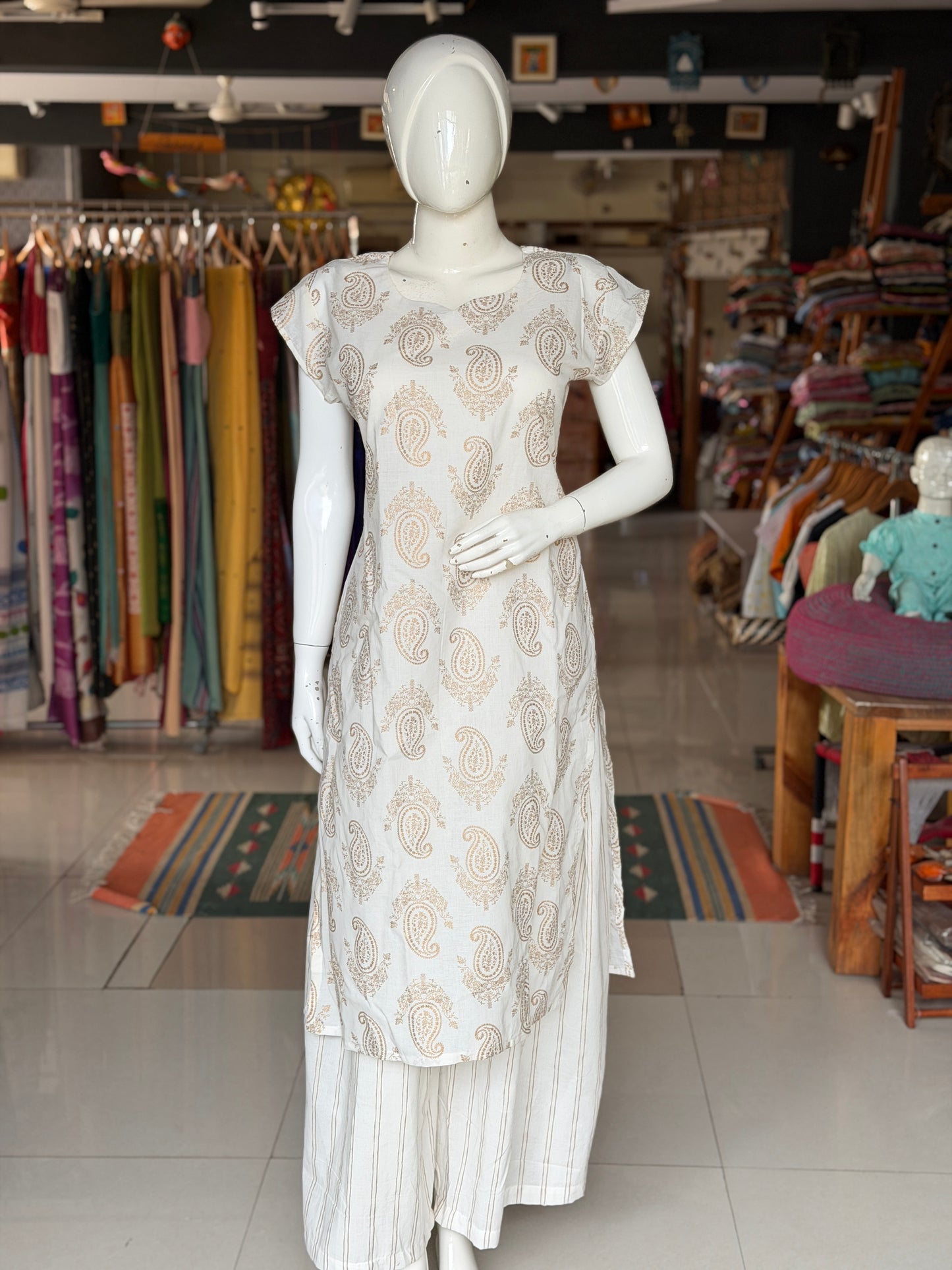 Off white paisley print cotton kurti paired with a matching stripes print barrel pants - 2 piece set